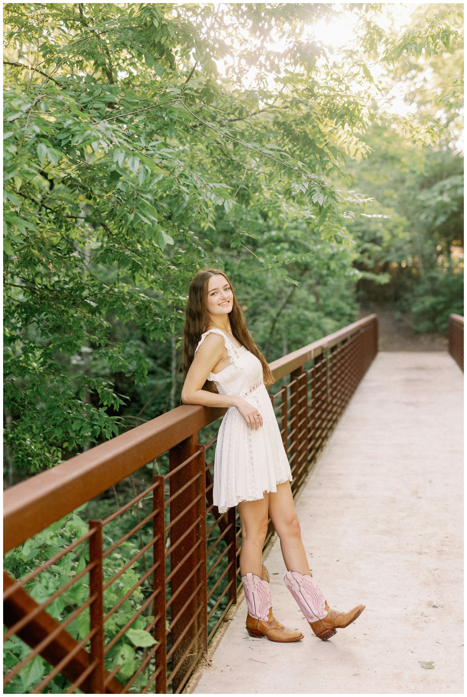 girl leaning on a bridge at The Houston Arboretum for Houston Garden Senior Session