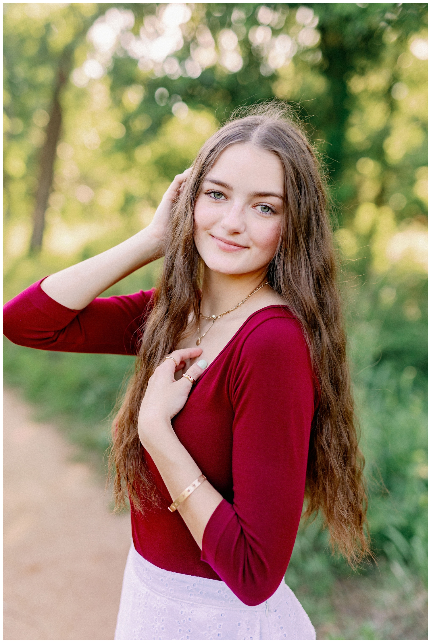 high school girl in maroon shirt staring at camera