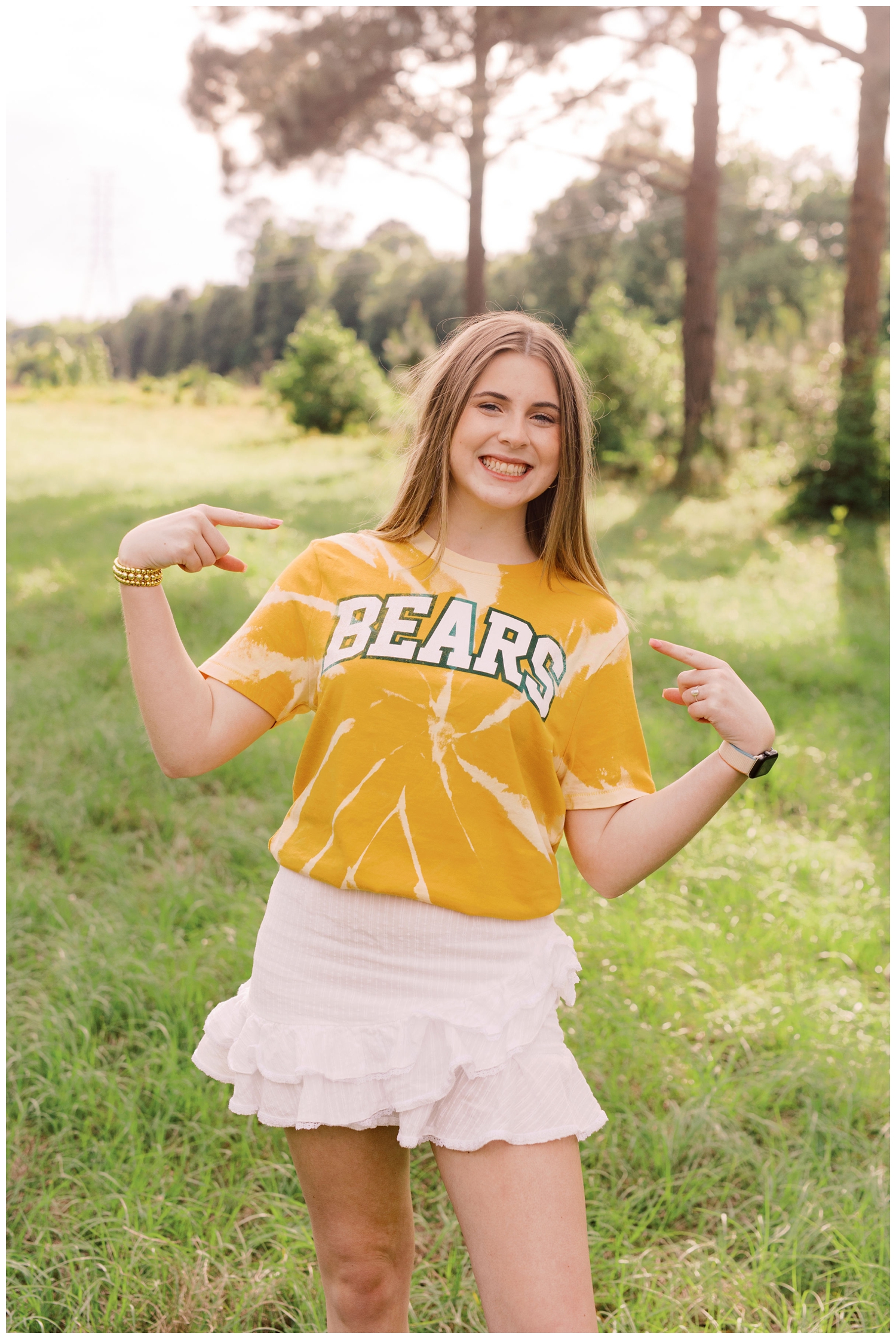 girl posing in a field in Baylor Bear tshirt for Houston Senior Model Team