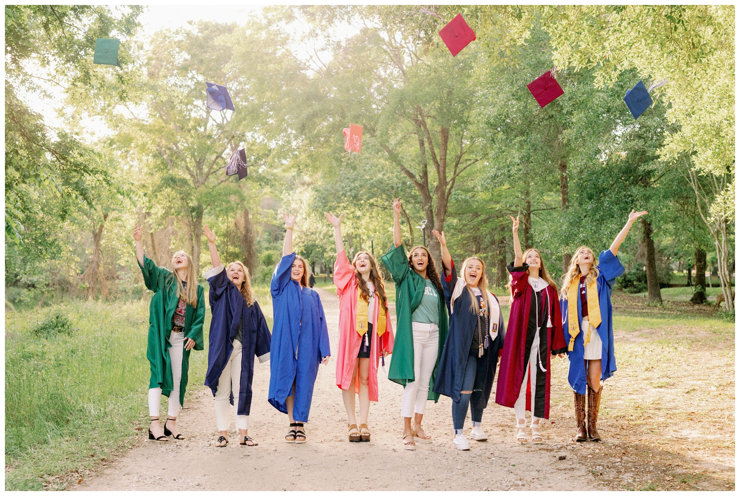 group of high school senior girls in cap and gown throwing caps in the air for Houston Senior Model Team