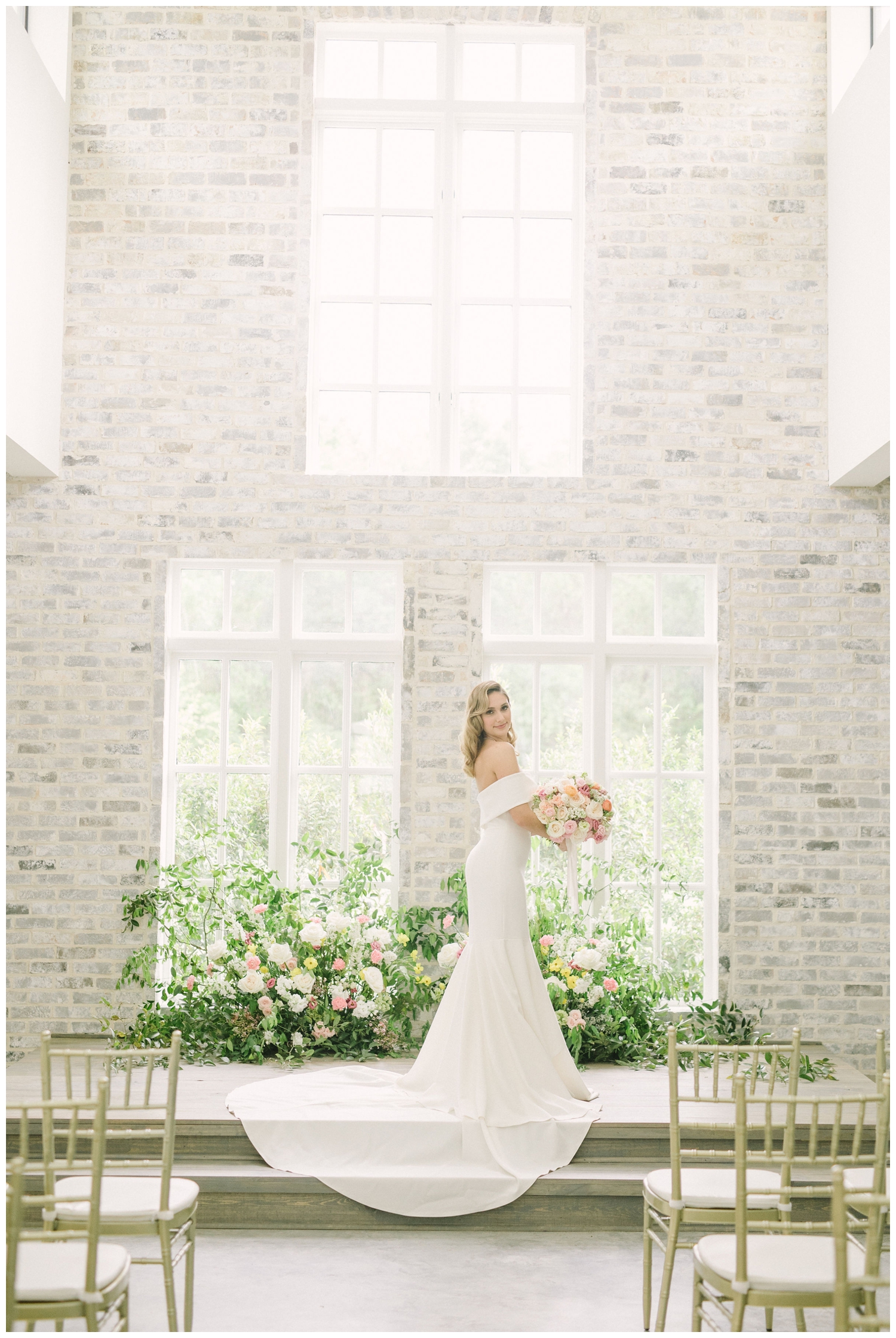 bride standing in front of floral display inside the chapel at The Peach Orchard