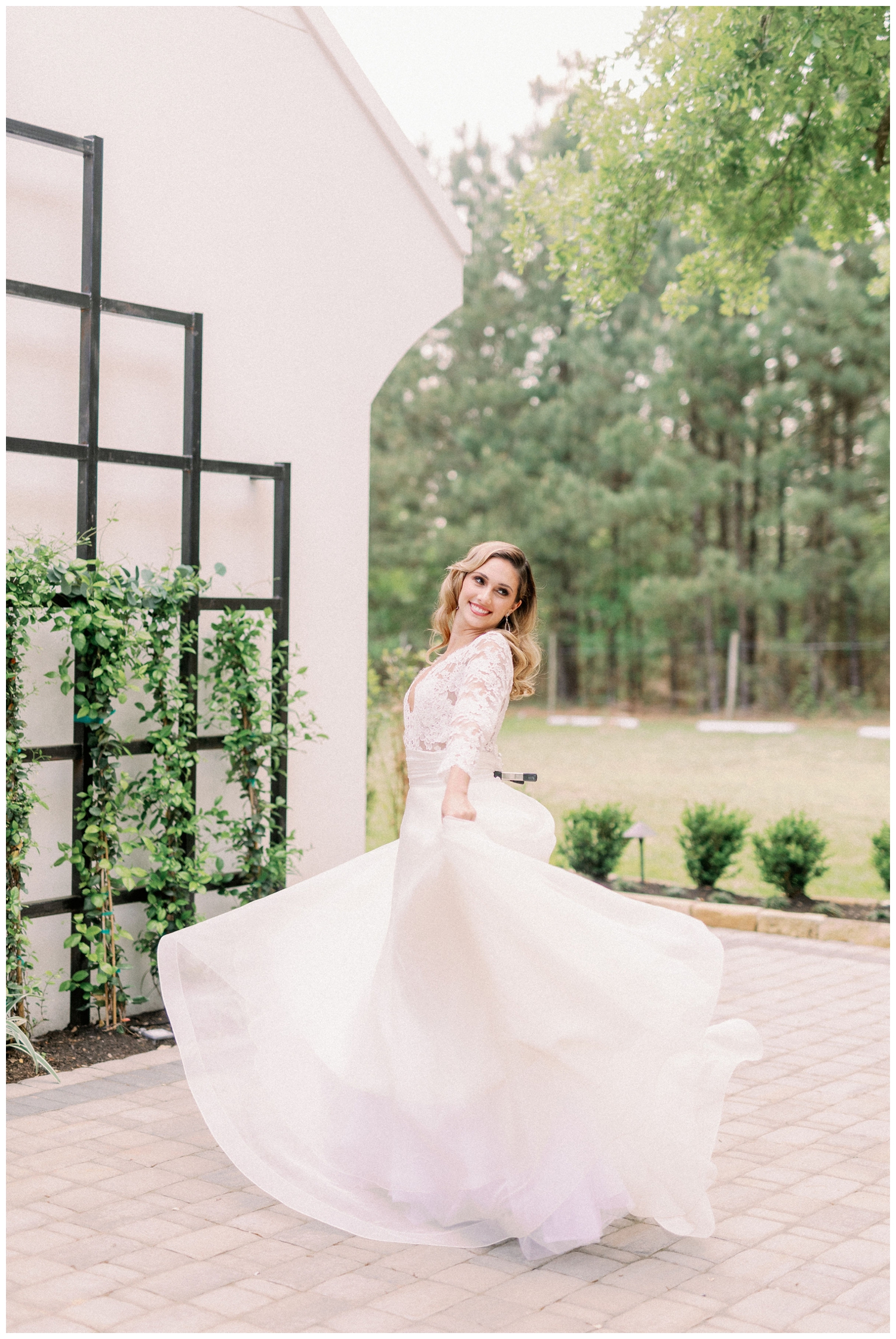 bride twirling white wedding gown outside The Peach Orchard wedding venue