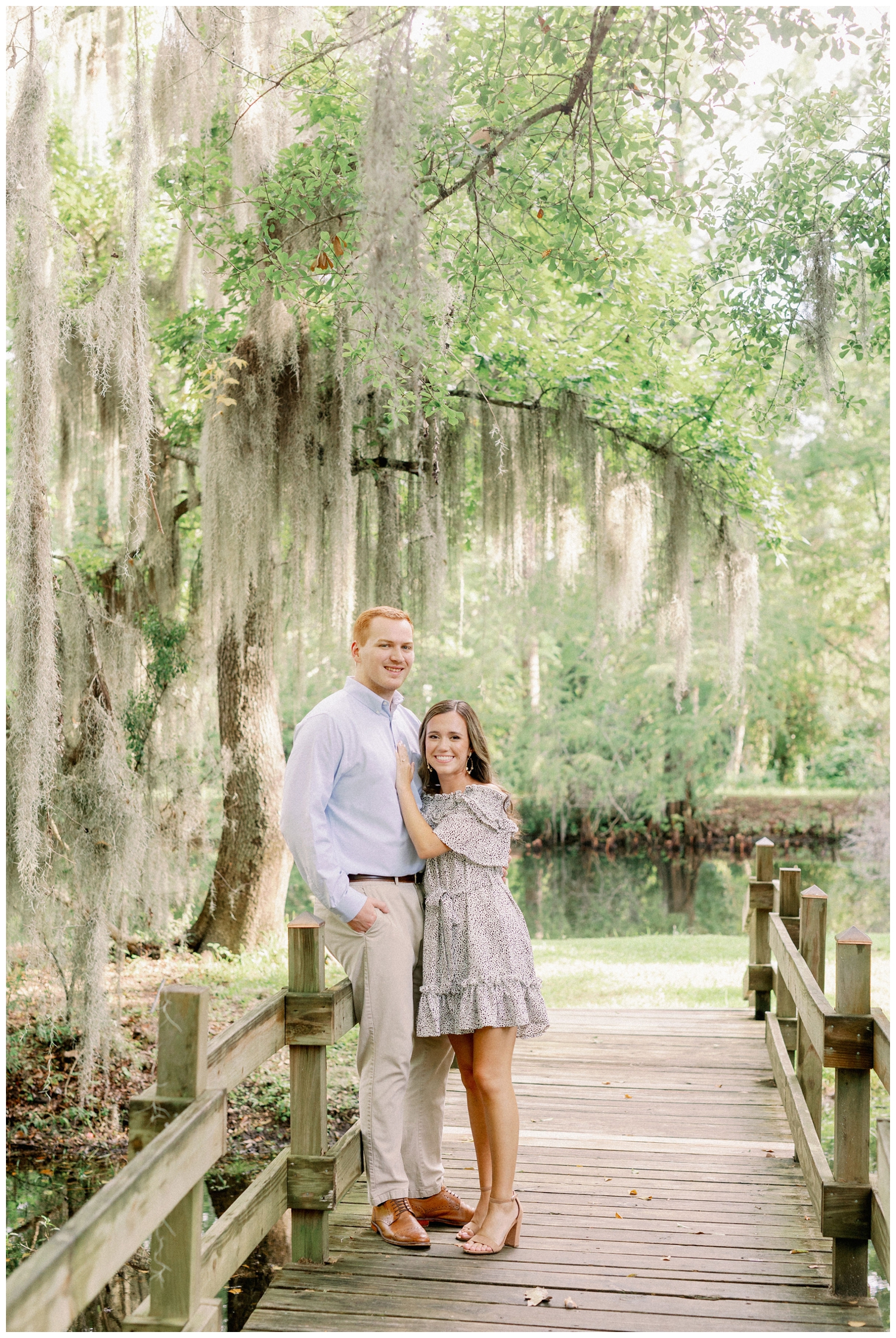 couple standing under a mossy tree on a bridge outdoors at Cy-Hope in Cypress Texas