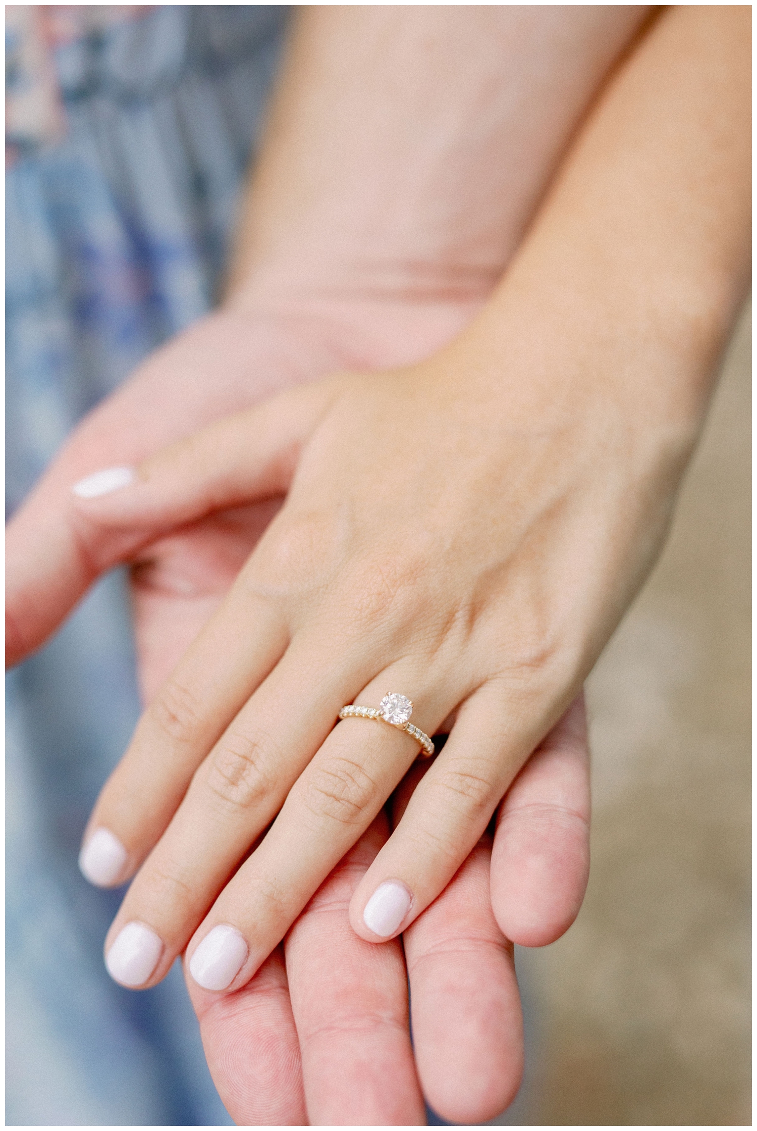 couple holding hands with detailed shot of wedding ring