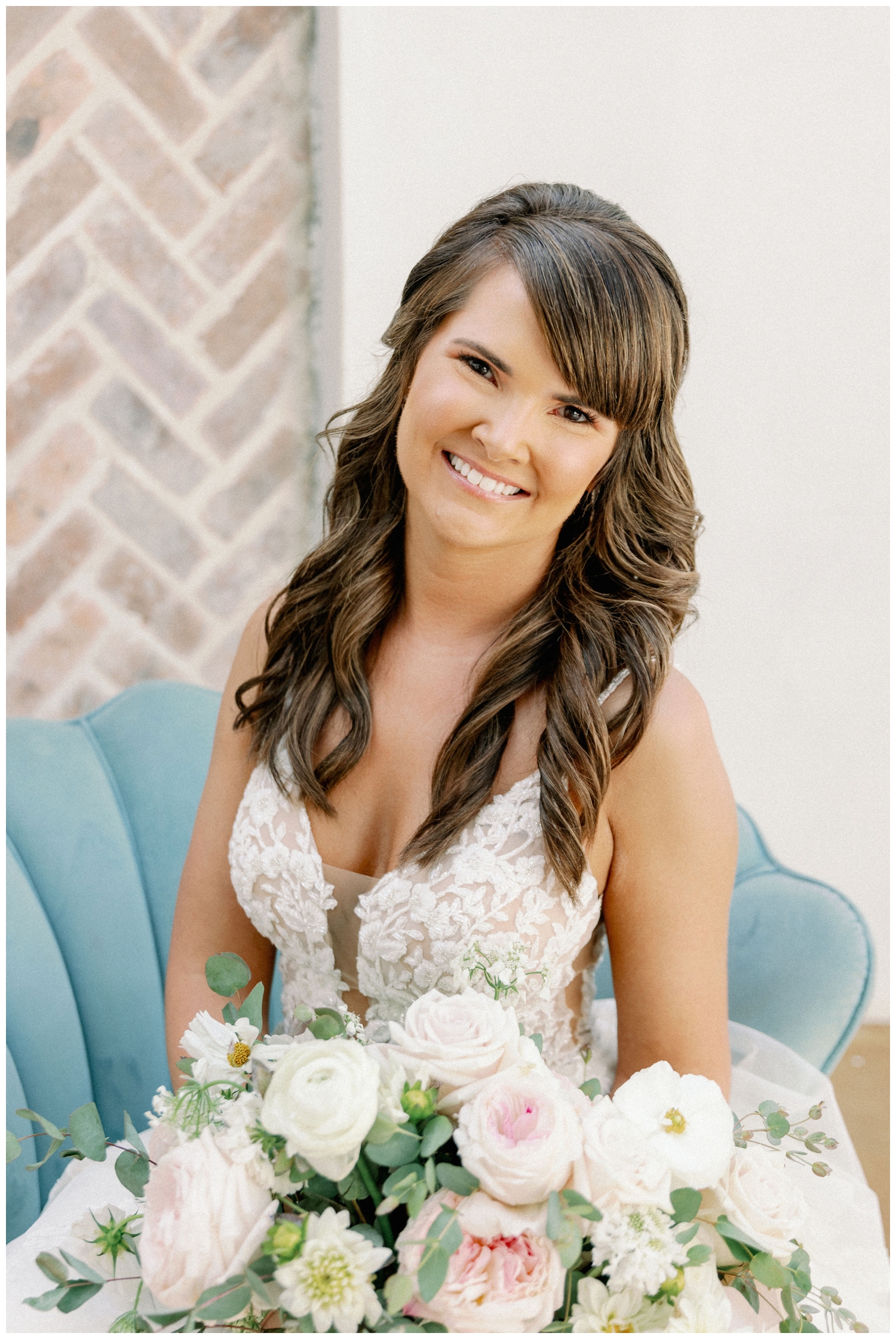 bride sitting in green chair smiling at camera