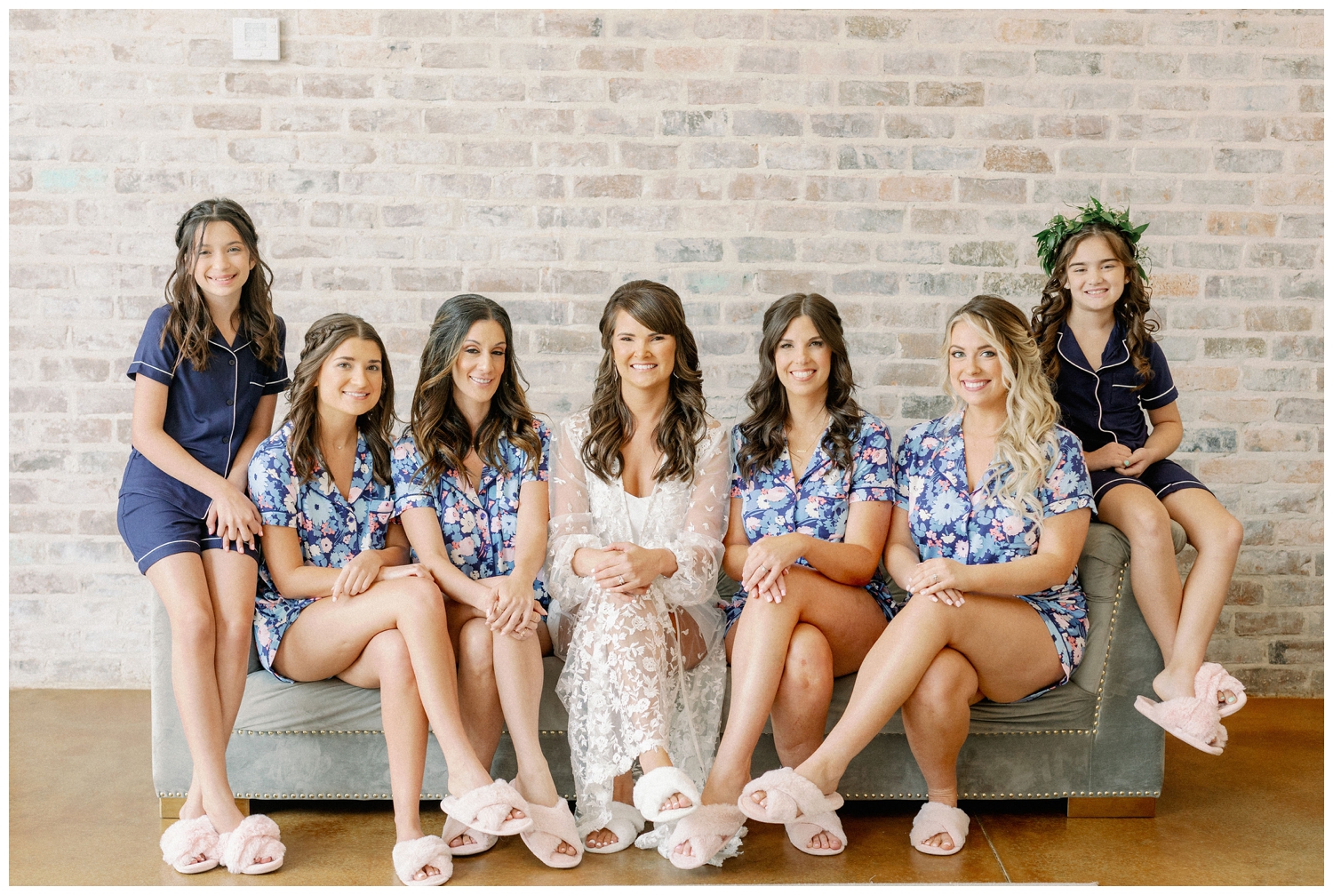bride and bridesmaids wearing matching floral blue pajamas inside Iron Manor