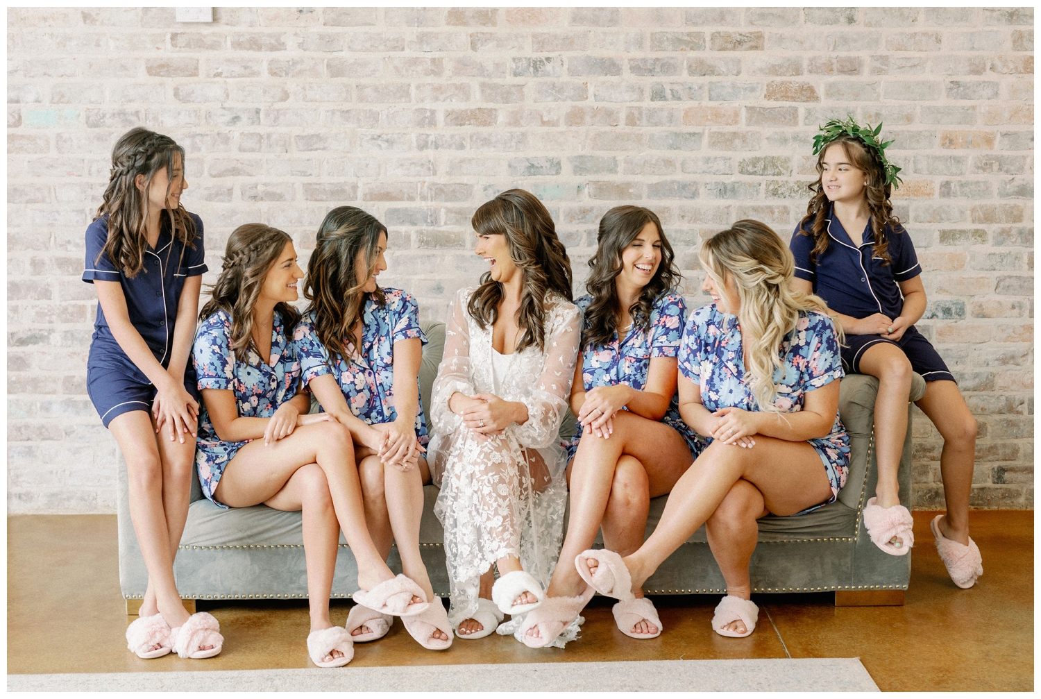 Iron Manor bridal suite with bride and bridesmaid sitting on couch in pajamas
