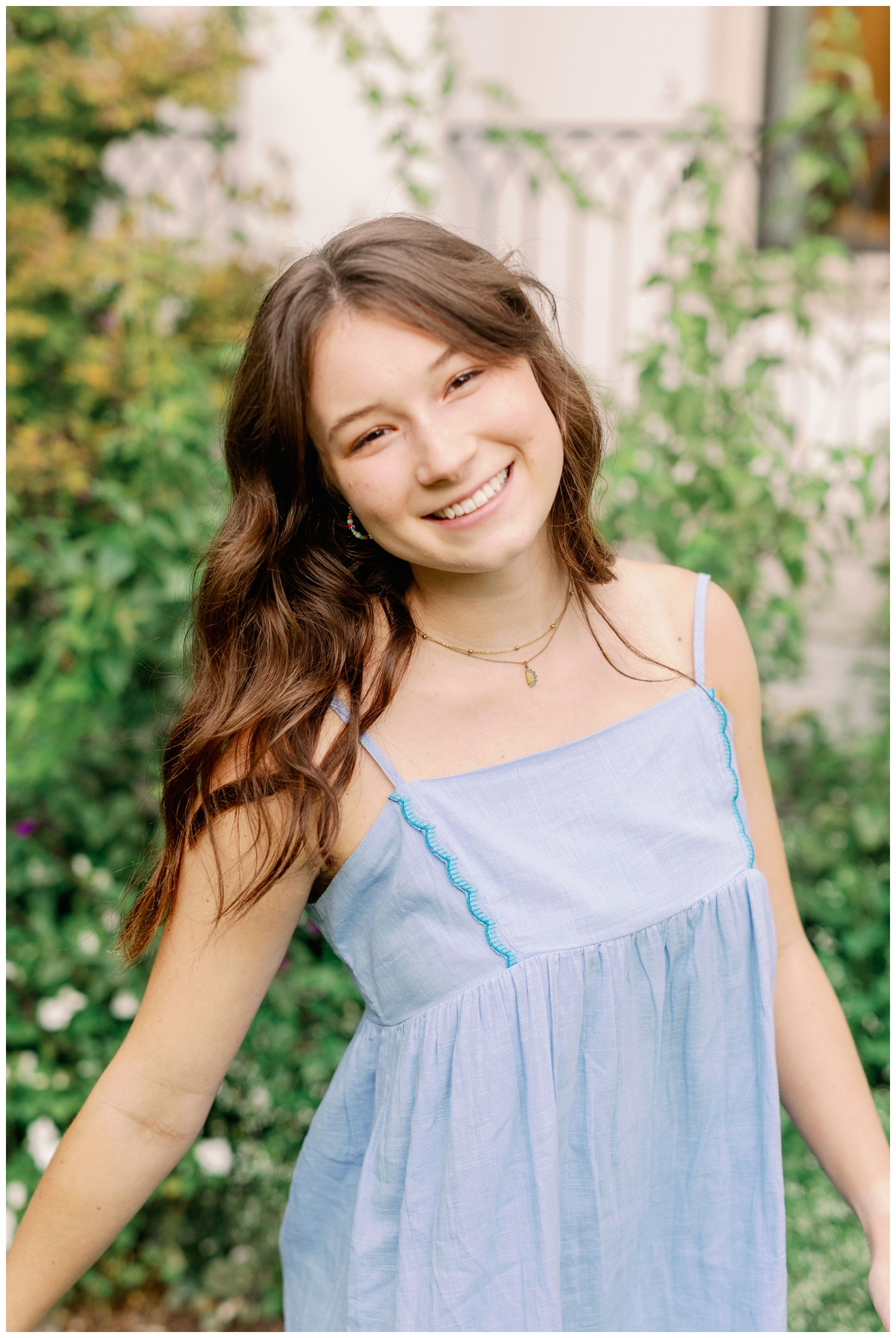 high school senior girl in blue dress posing for outdoor portrait for senior spokesmodel team Houston