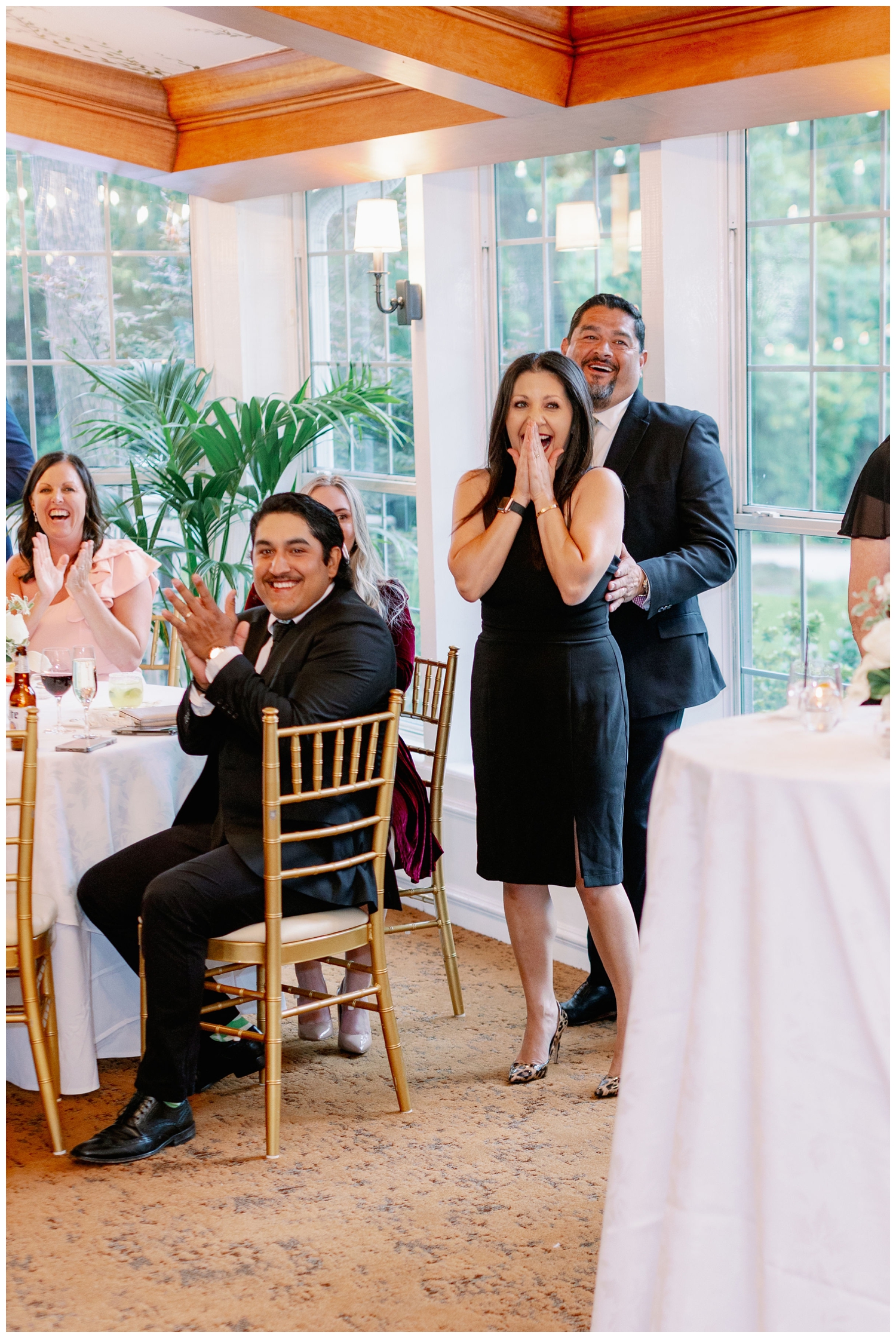 couple reacting to a toast inside The Manor House at The Houstonian Hotel wedding