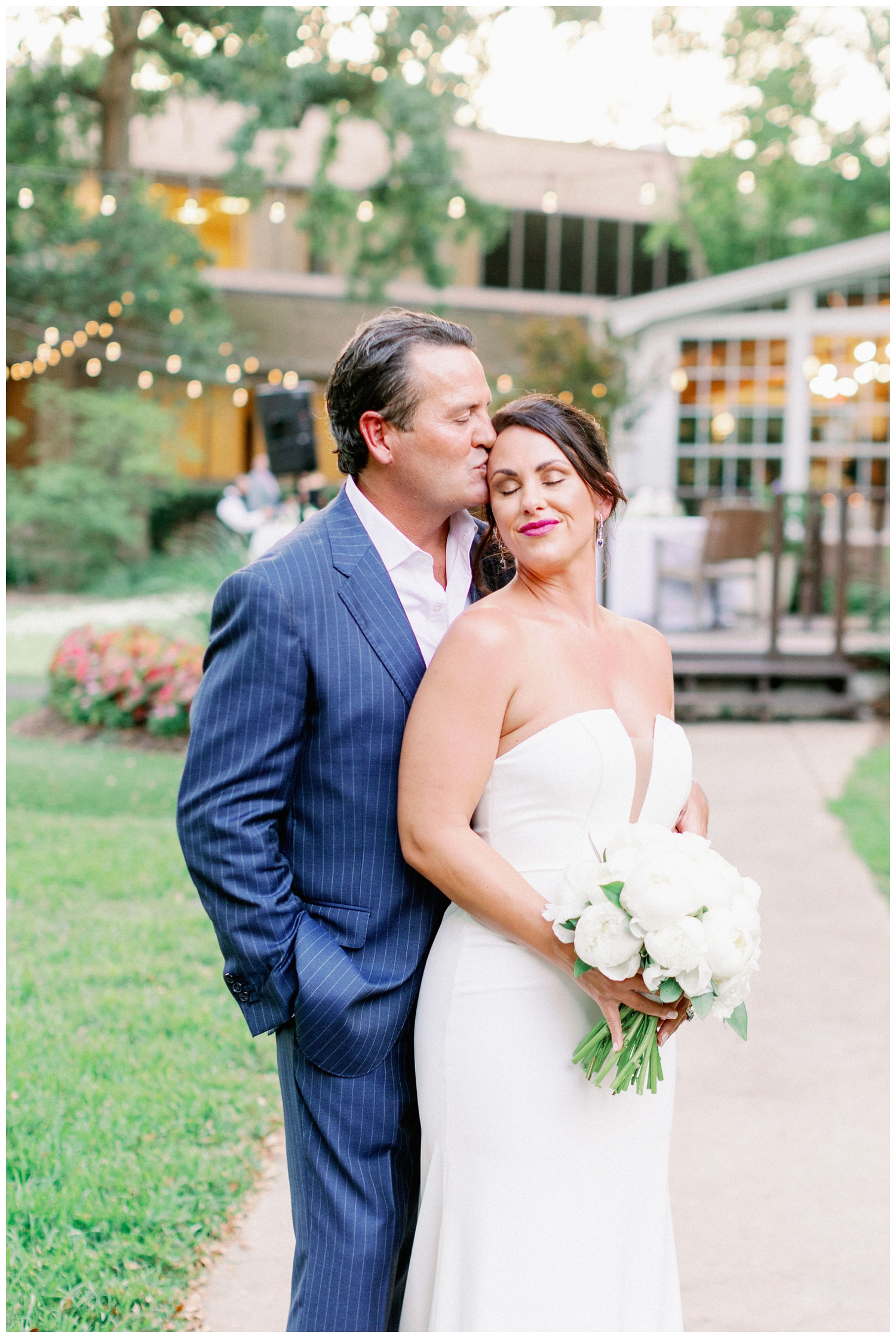 groom kissing his bride on the forehead for portrait The Houstonian Hotel wedding