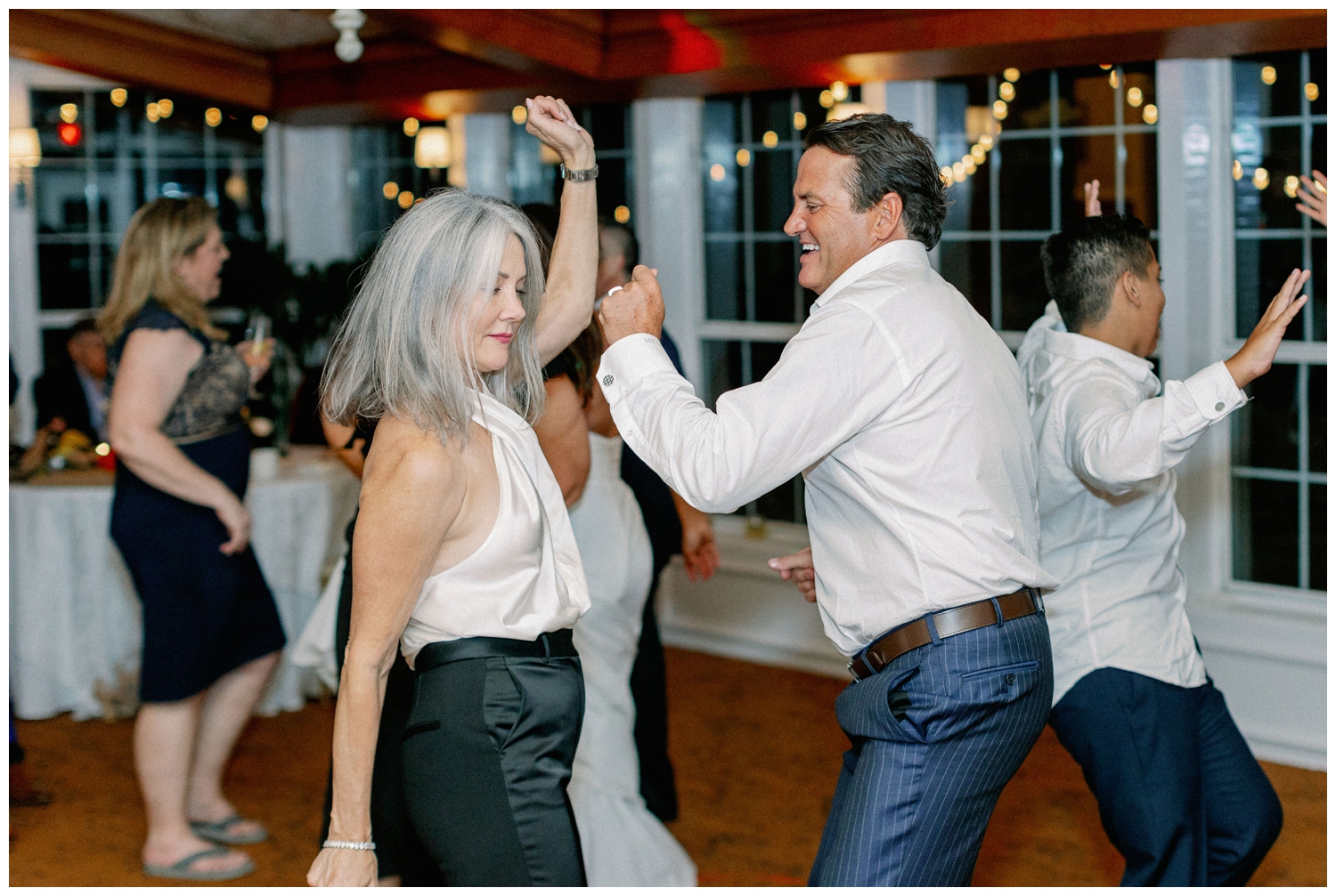 groom dancing with guest during reception at The Manor House