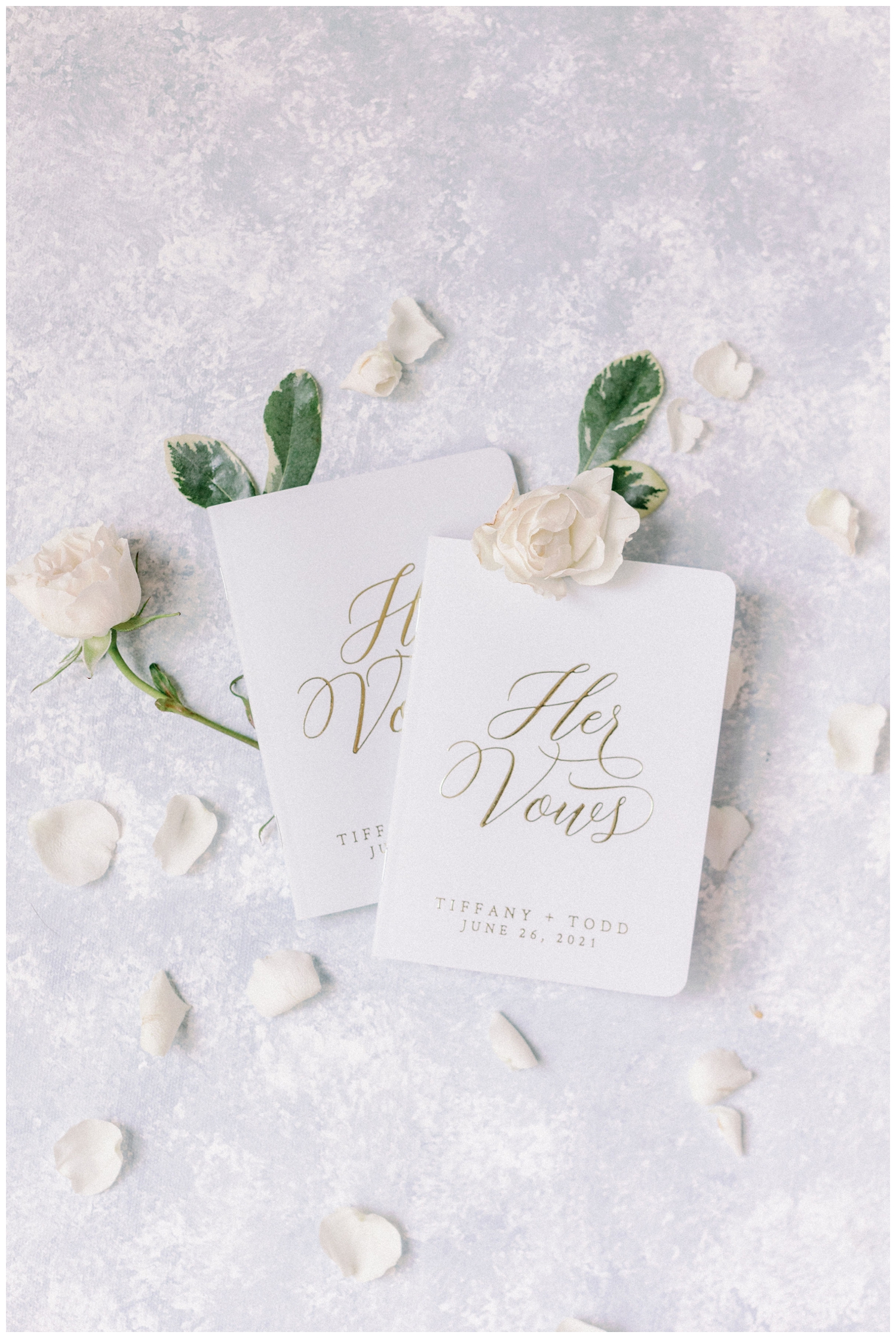 his and her vow books with white florals