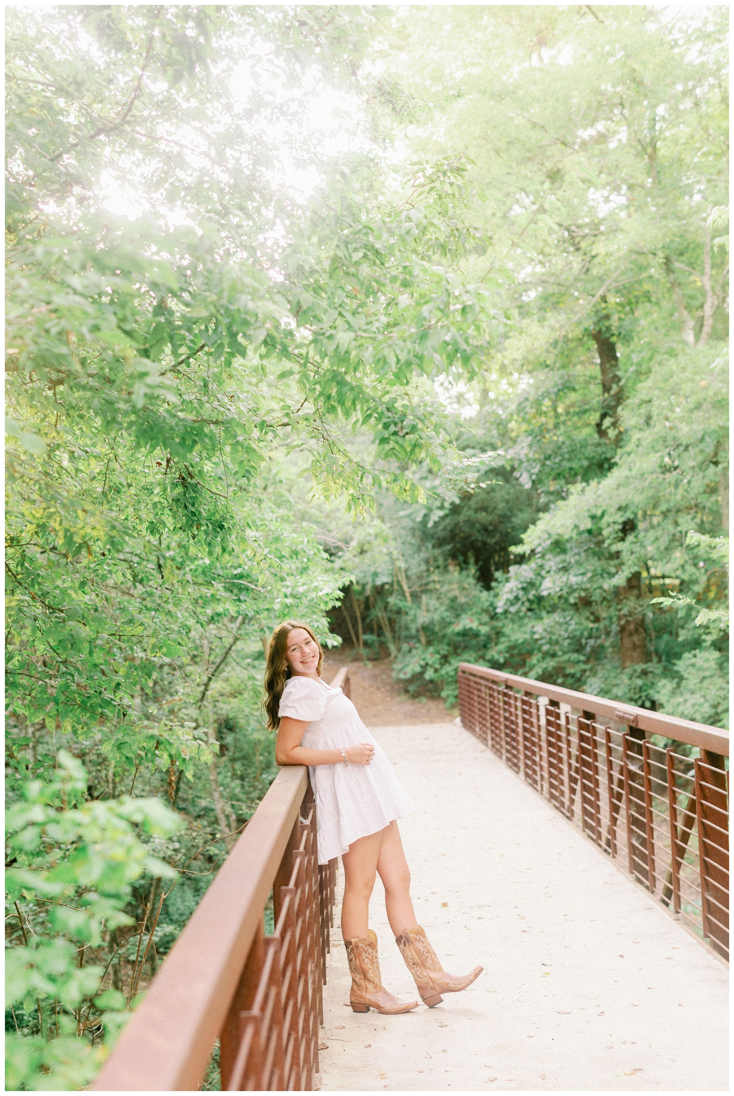 girl leaning on bridge at Houston Arboretum