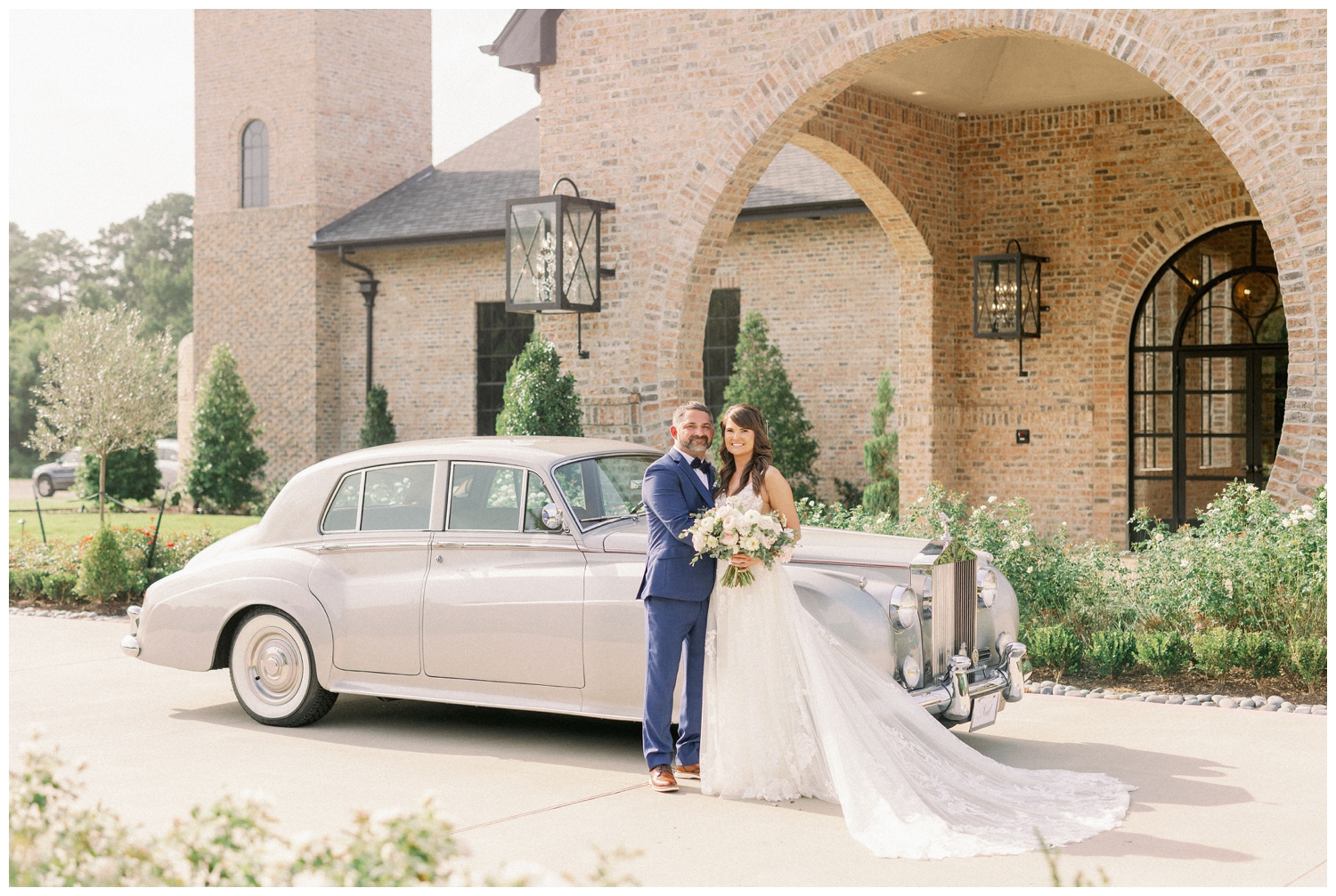 bride and groom in front of classic white car