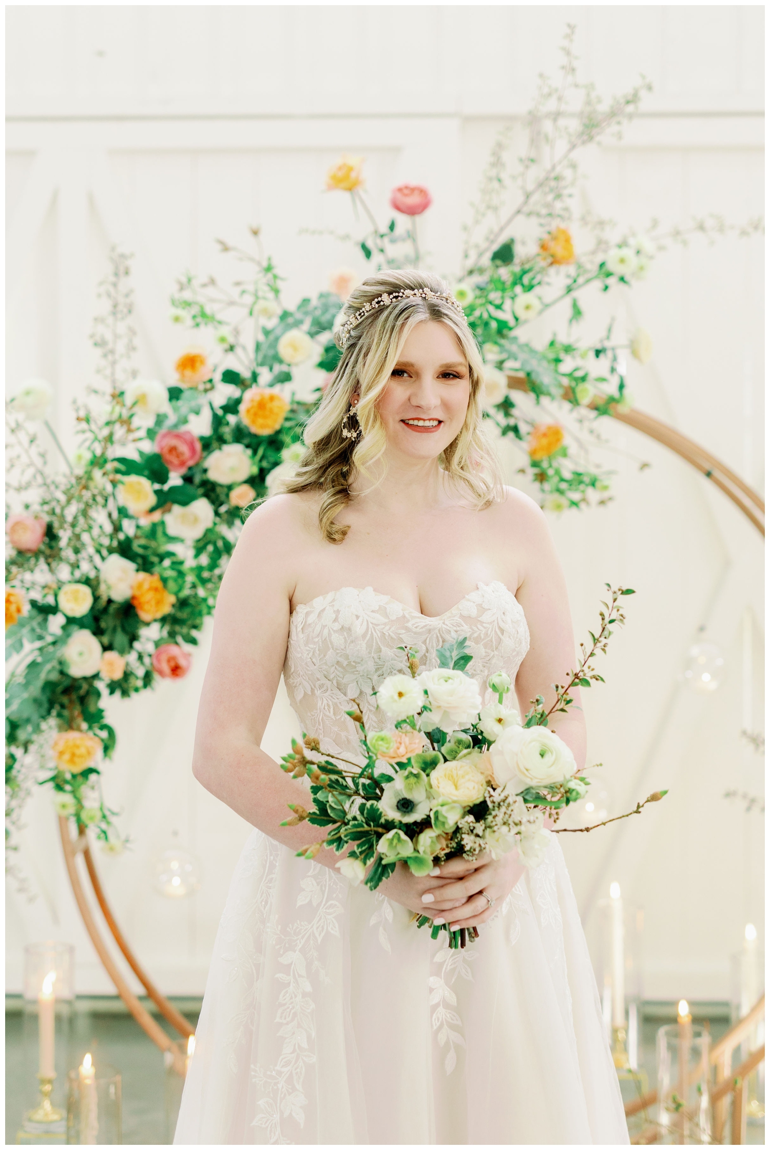 bride posing inside The Farmhouse Wedding and Event Venue standing in front of floral hoop installation