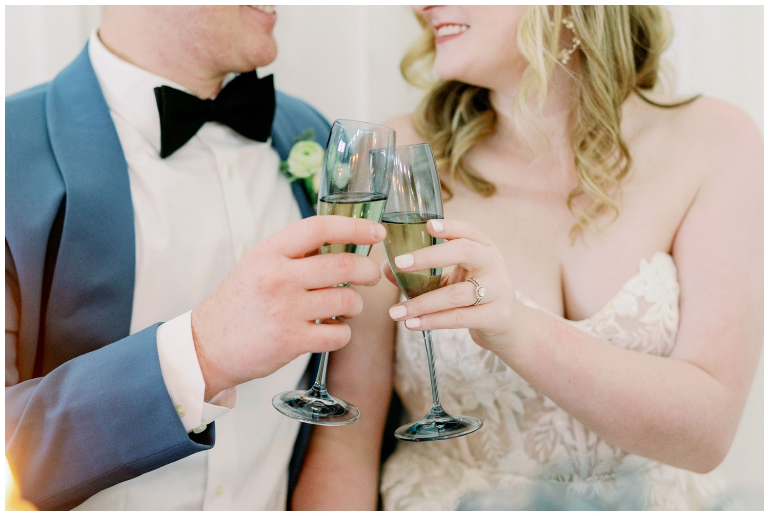 bride and groom toasting with light blue champagne flutes at The Farmhouse Wedding