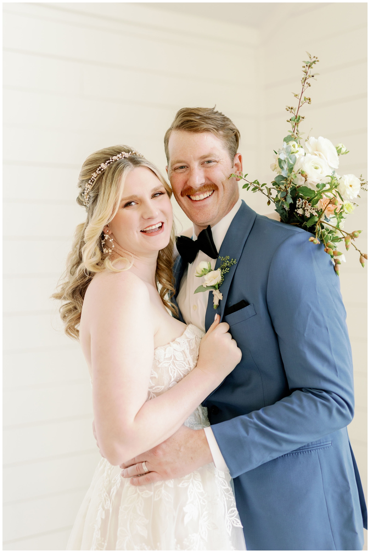 bride and groom laughing during portraits at The Farmhouse Wedding and Event Venue