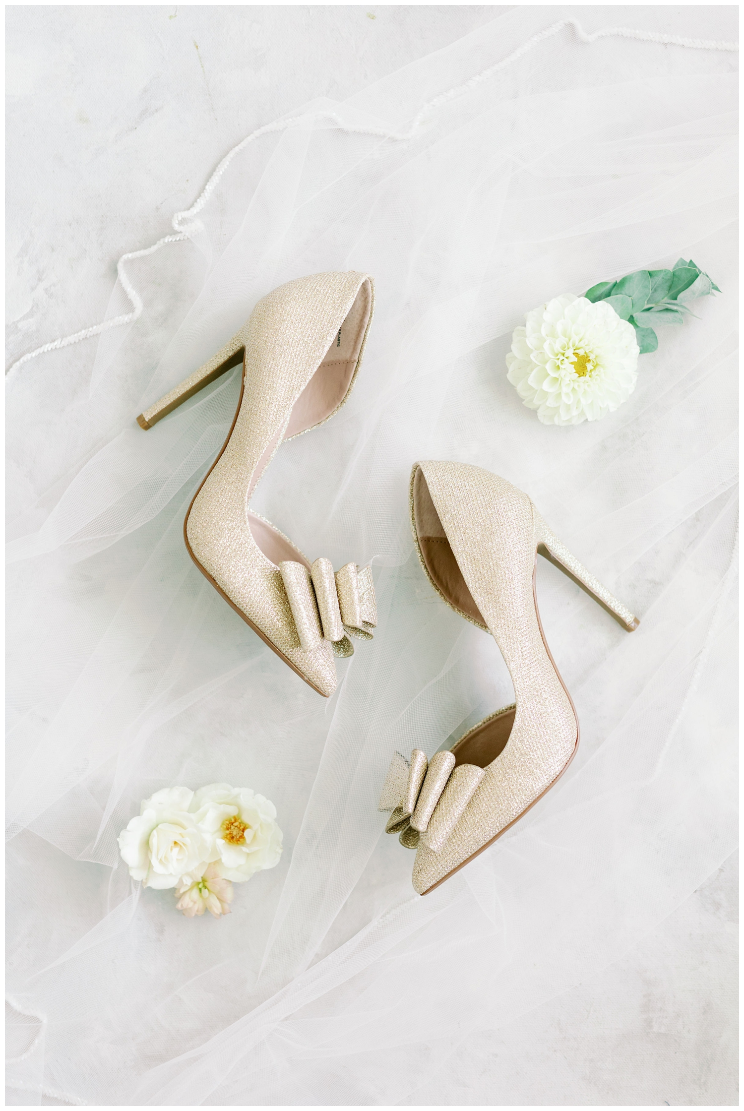 cream wedding heels on a white veil