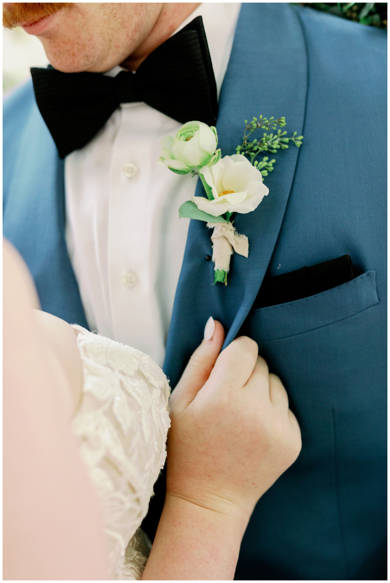 detail shot of bride's hand on grooms jacket