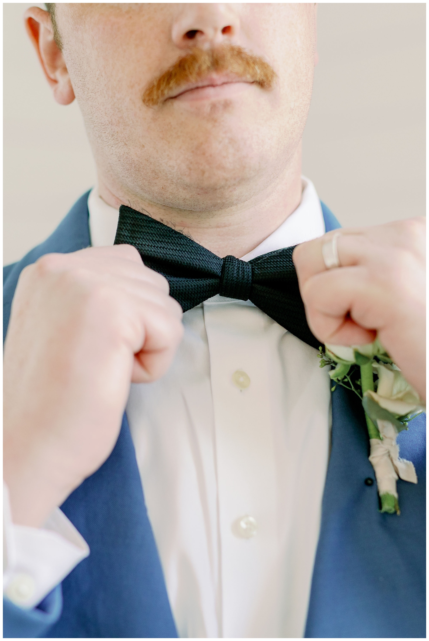 groom's hands fixing bow tie The Farmhouse Wedding and Event Venue