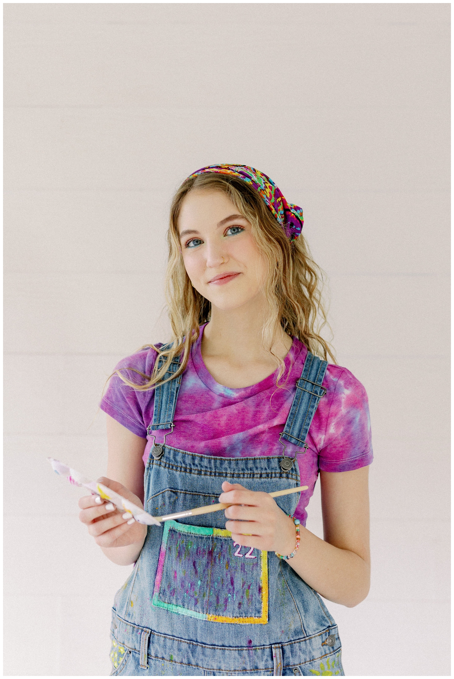 colorful Houston senior photos with girl holding paint supplies