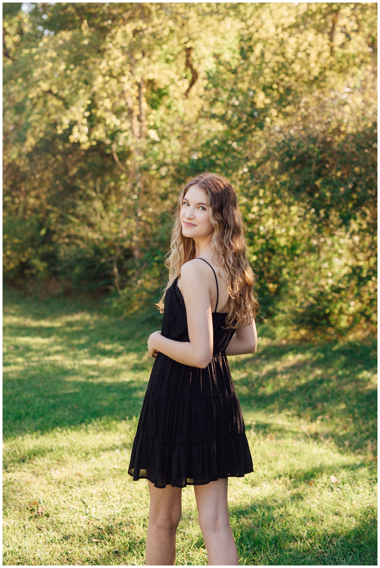 girl in black dress looking over shoulder for Reed Gallagher Photography
