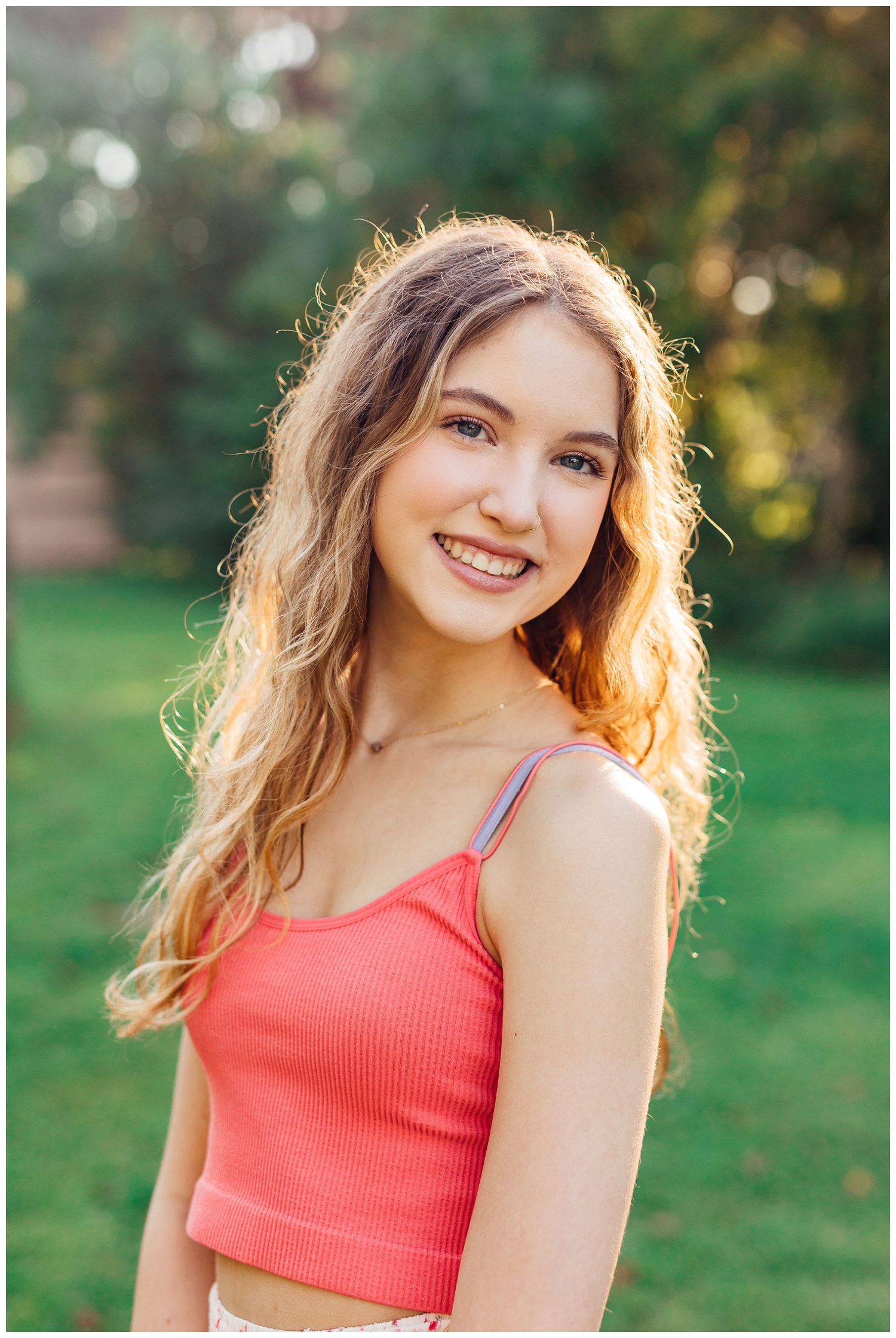 closeup of girl smiling with sunlight beaming in hair for colorful Houston senior photos