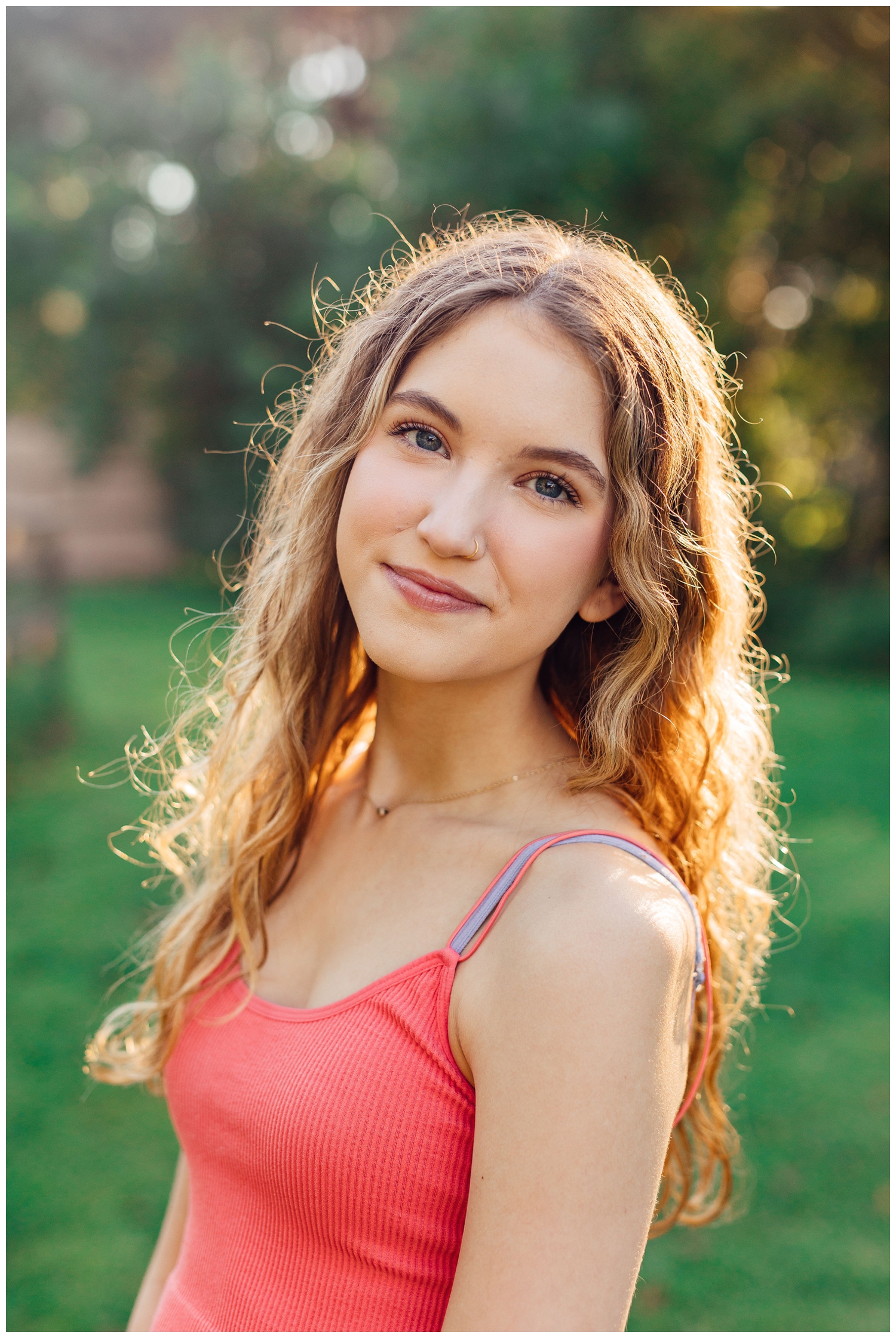 gir in coral top smiling for colorful Houston senior photos