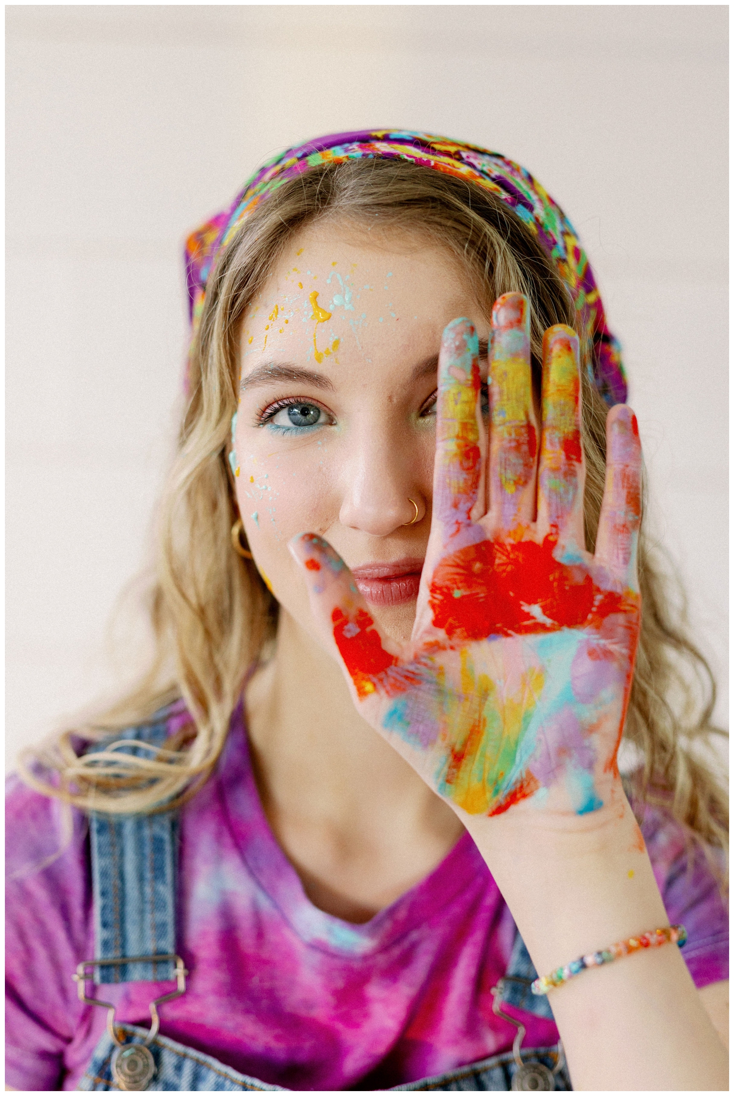 closeup of girl with painted hand in front of face for colorful Houston senior photos