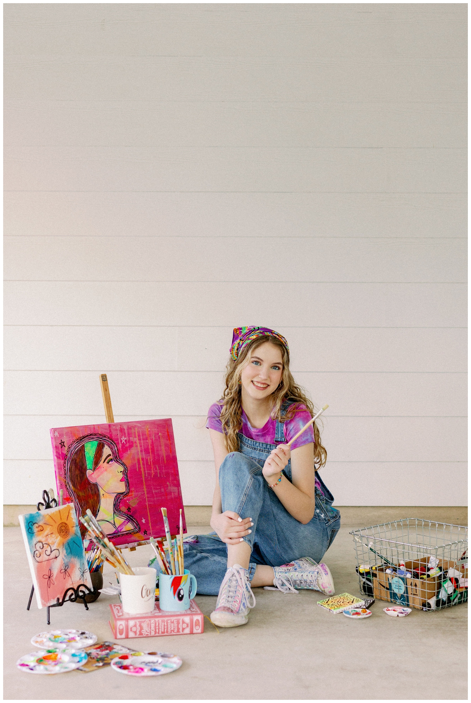 girl sitting with painting supplies and canvas colorful Houston senior photos