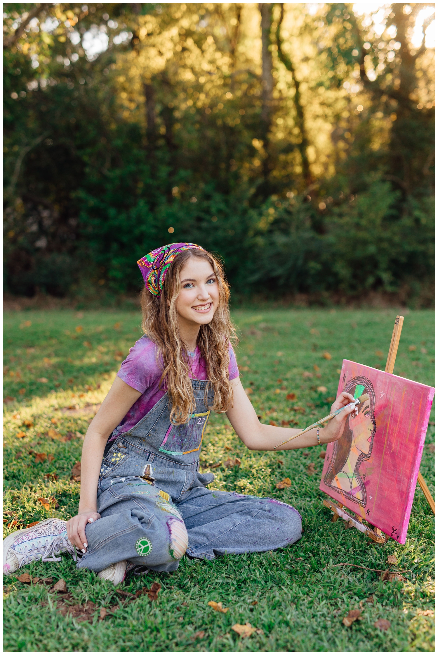 colorful Houston senior photos with girl in denim overalls and purple shirt painting a canvas