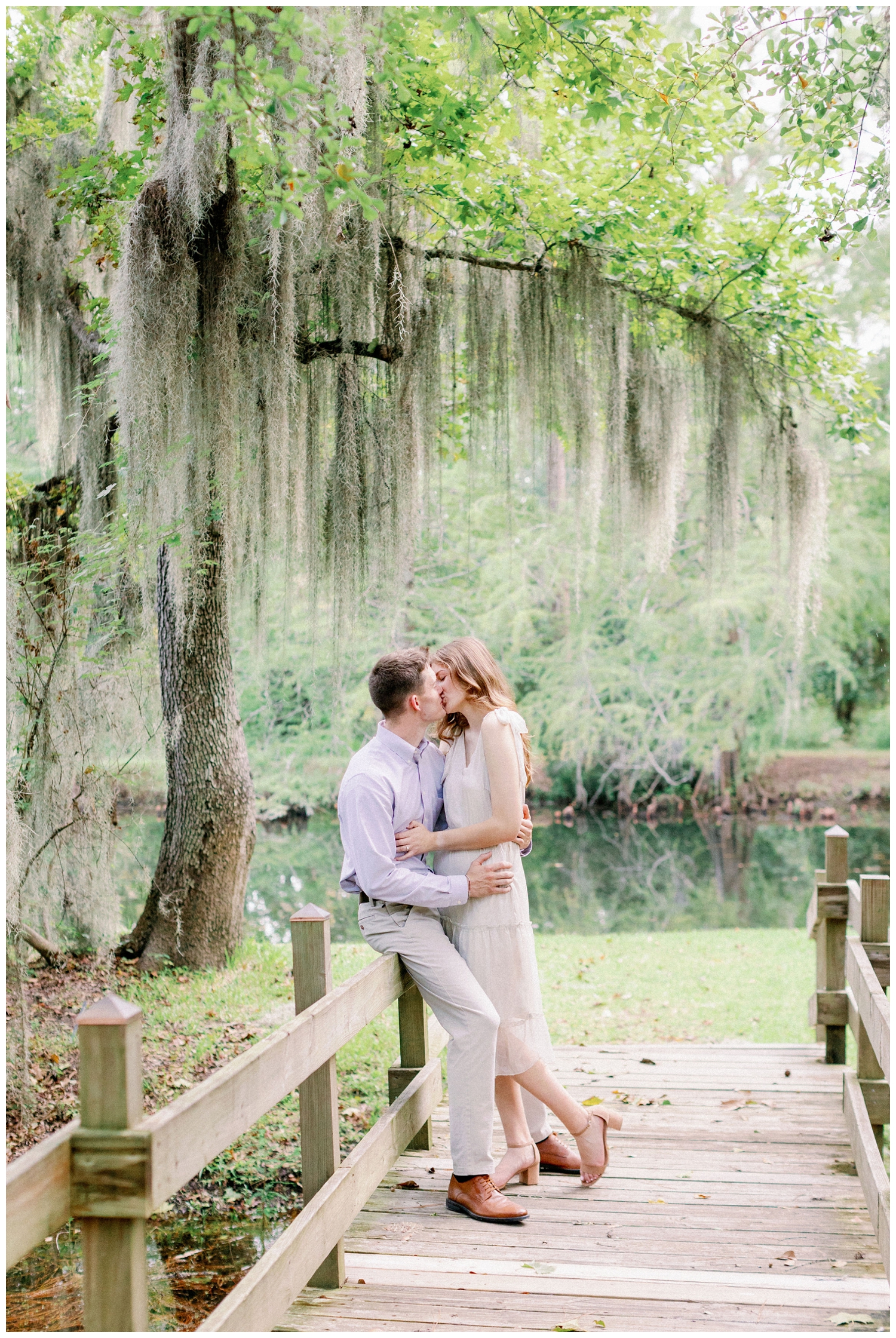 couple kissing under mossy tree at Cy-Hope Cypress engagement photos
