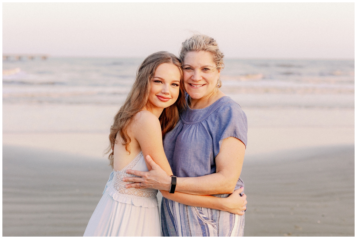 mother and daughter hugging on Galveston beach