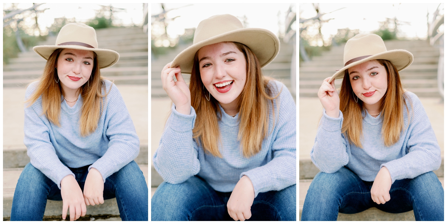 closeup portraits of girl sitting on stairs with beige hat and blue sweater for senior pictures downtown Houston