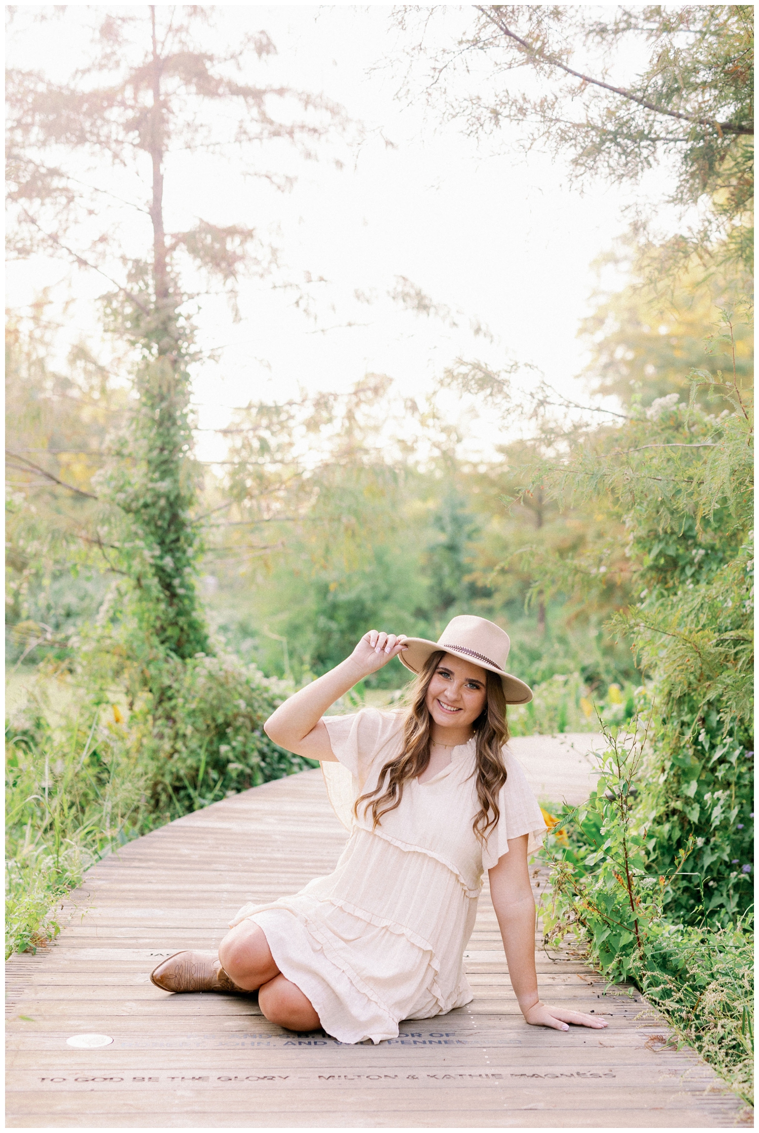 girl in cream sundress wearing cowboy hat senior pictures Houston Arboretum