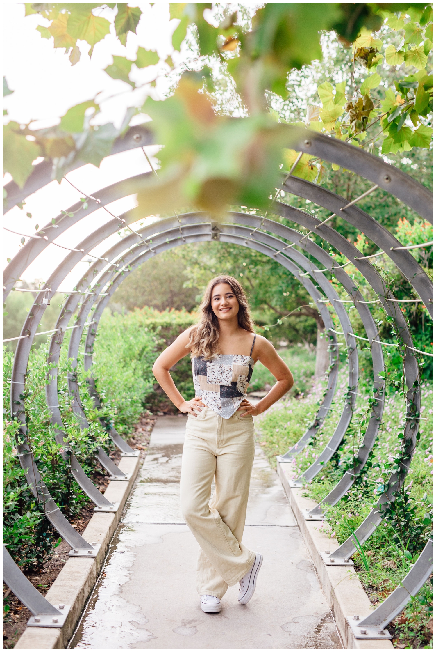 girl in cream pants and patchwork shirt standing in garden rings for Reed Gallagher Photography