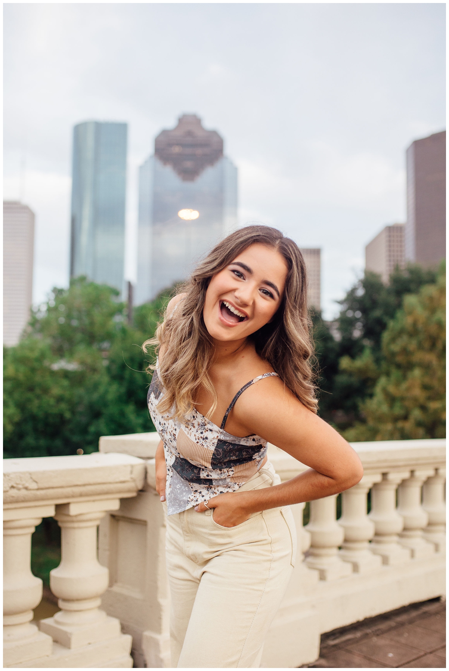 girl laughing on Sabine Street Bridge for Houston senior dance photographer