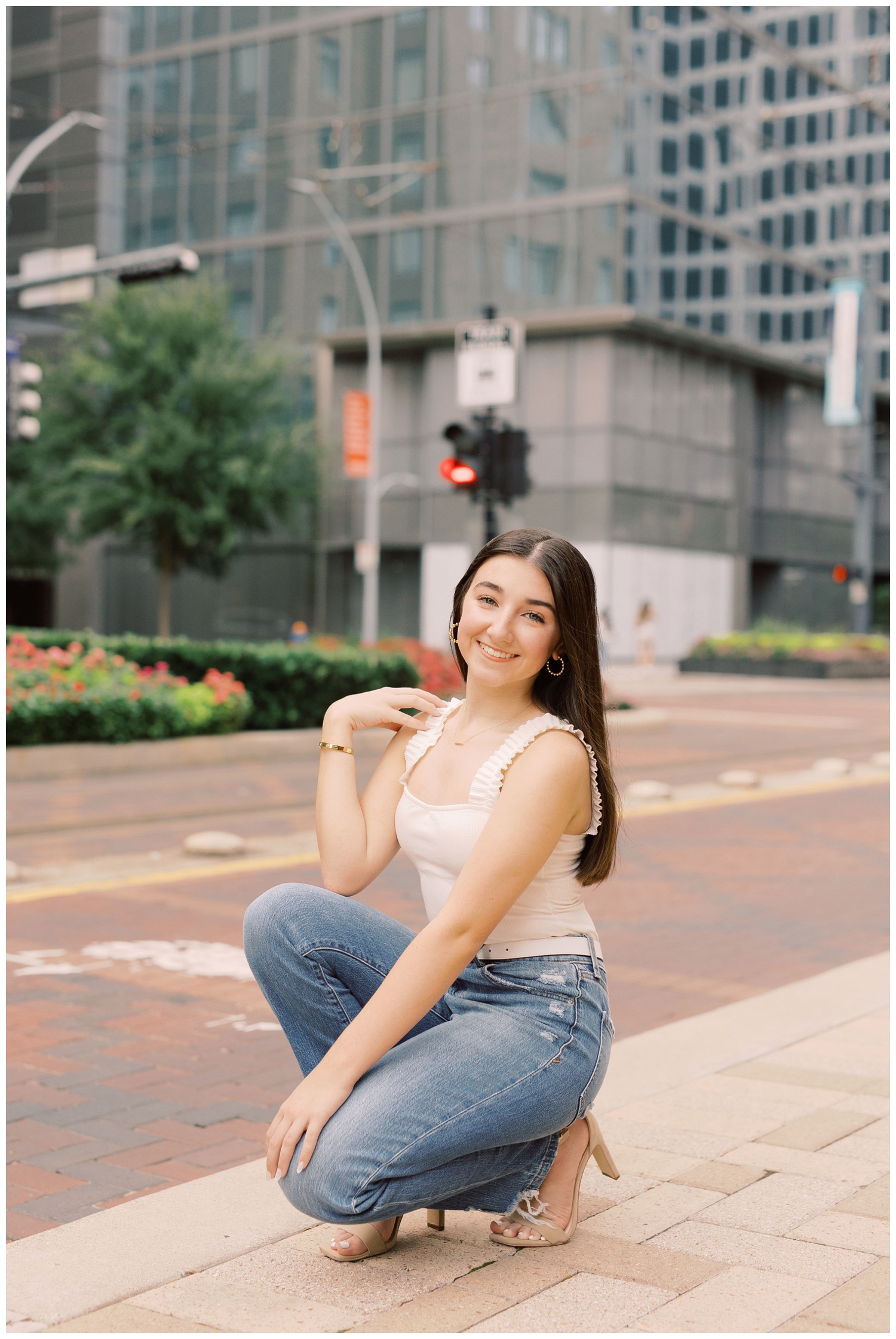 girl squatting on Main Street downtown Houston