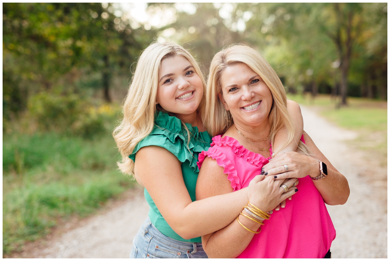 girl in green shirt hugging her mom during colorful Houston senior photography