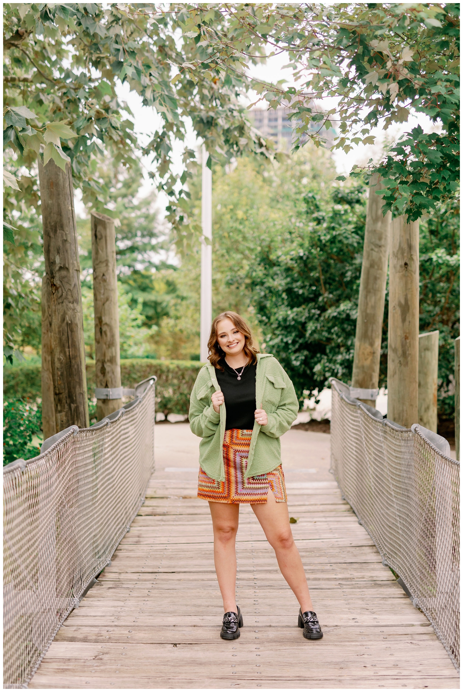 girl standing on bridge senior pictures in Houston, Texas