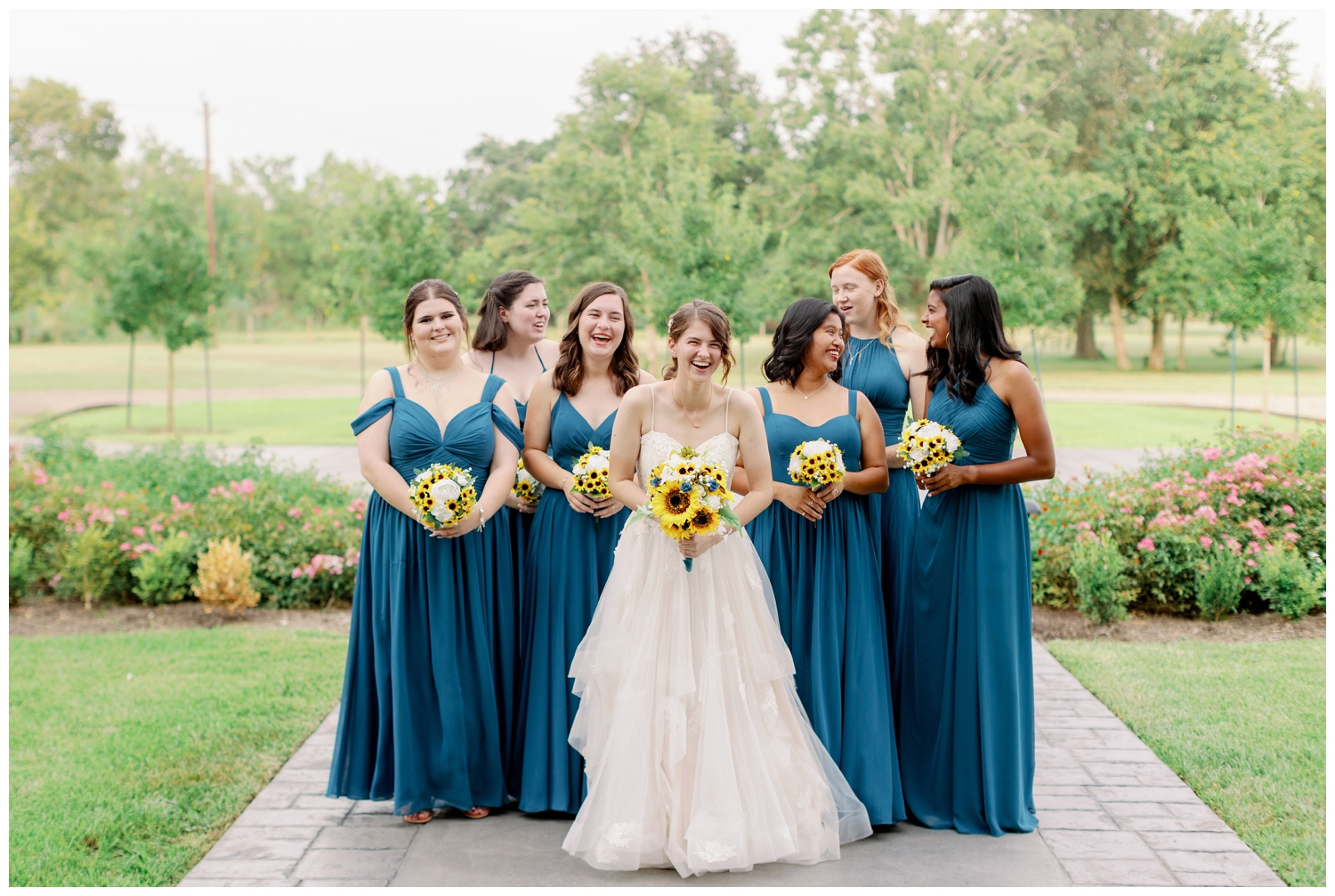 bride with bridesmaids in blue dresses walking and laughing The Oaks at the Oak Plantation wedding