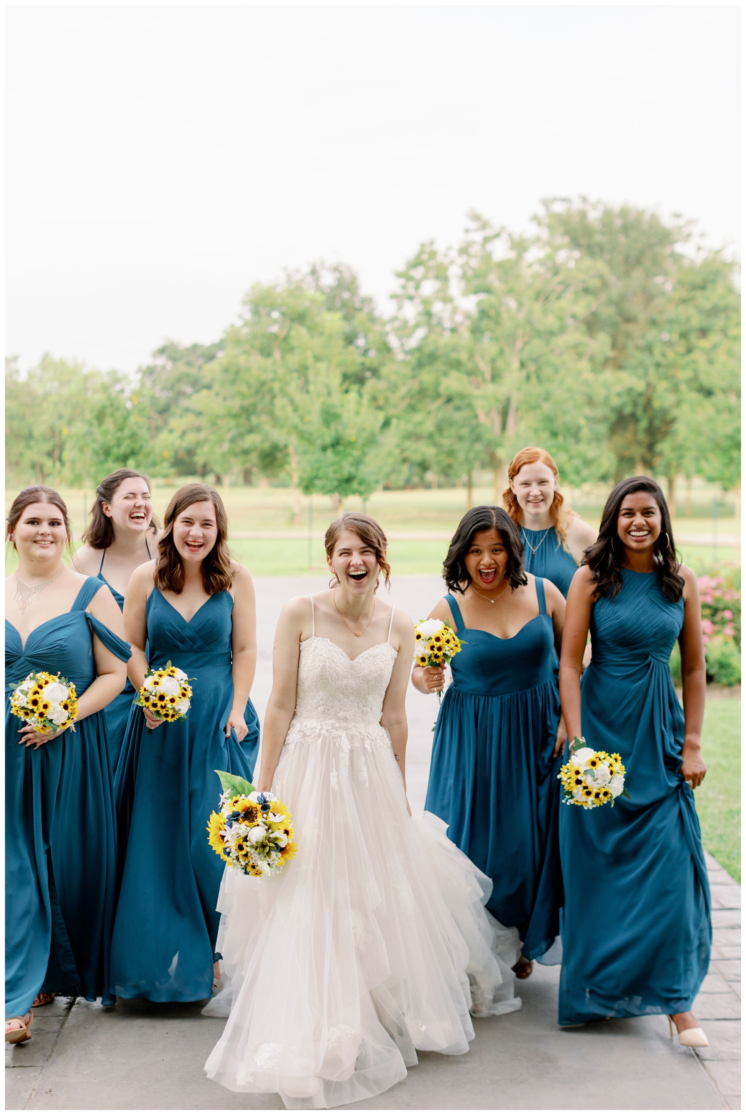 bride laughing with bridesmaids outside The Oaks at the Oak Plantation wedding