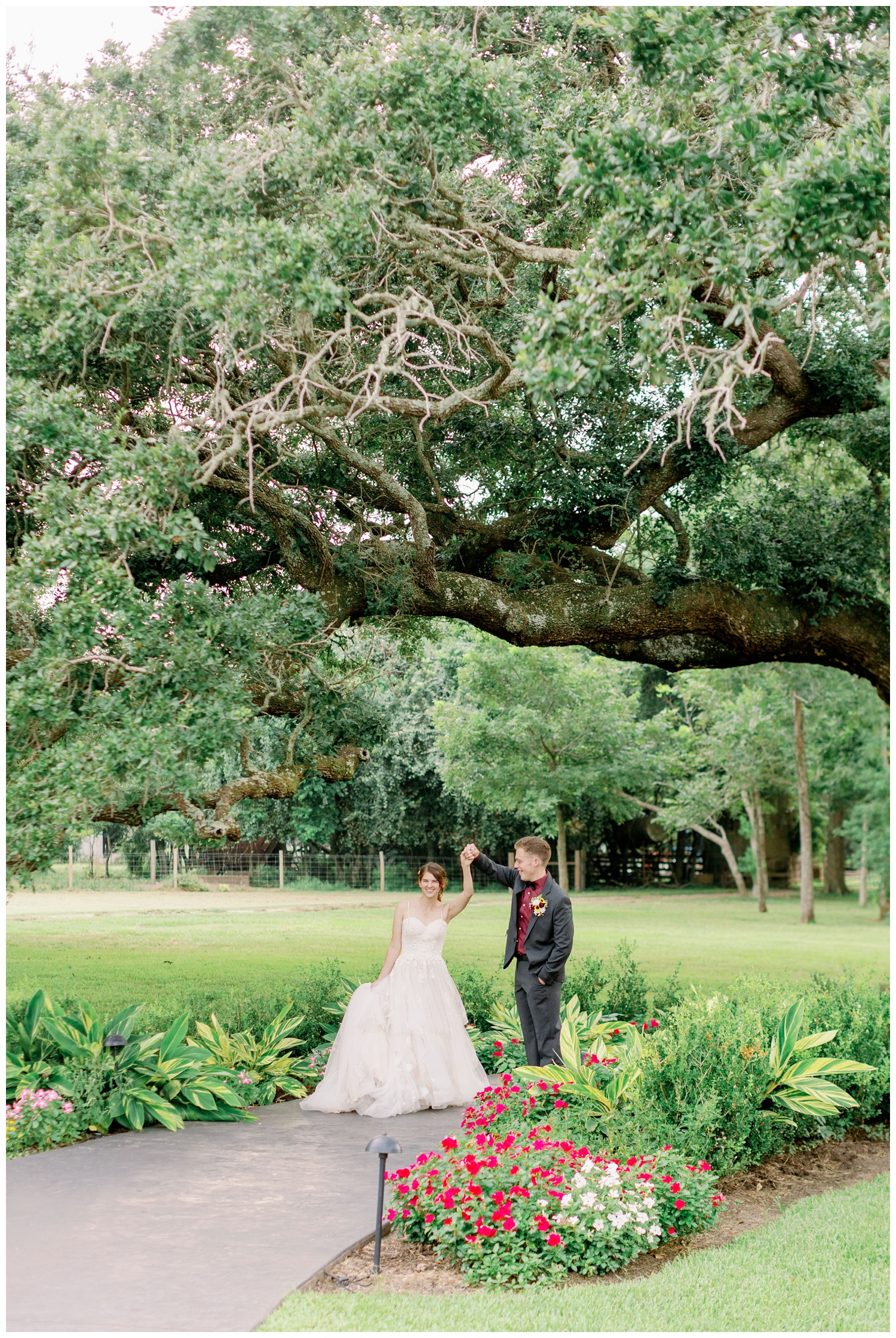 groom twirling bride under the oak tree at The Oaks at the Oak Plantation wedding