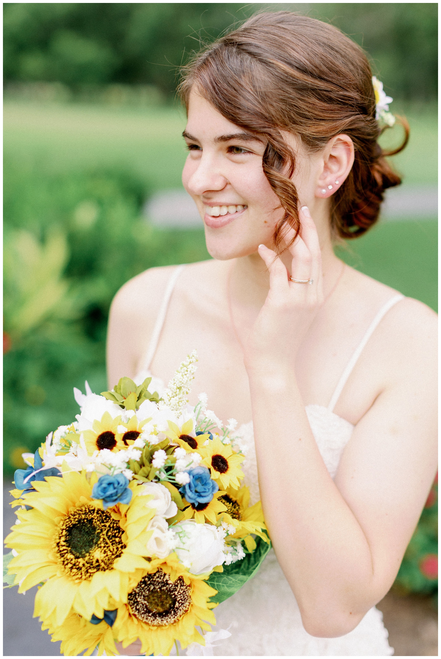 bride smiling and touching face with hand for The Oaks at Oak Plantation wedding