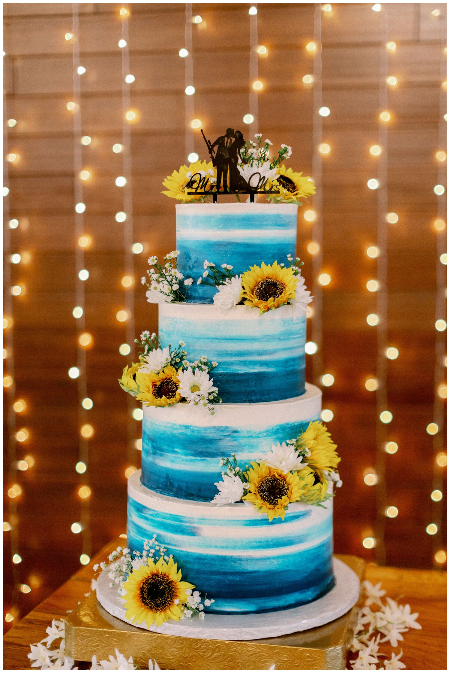 blue and white cake with sunflowers