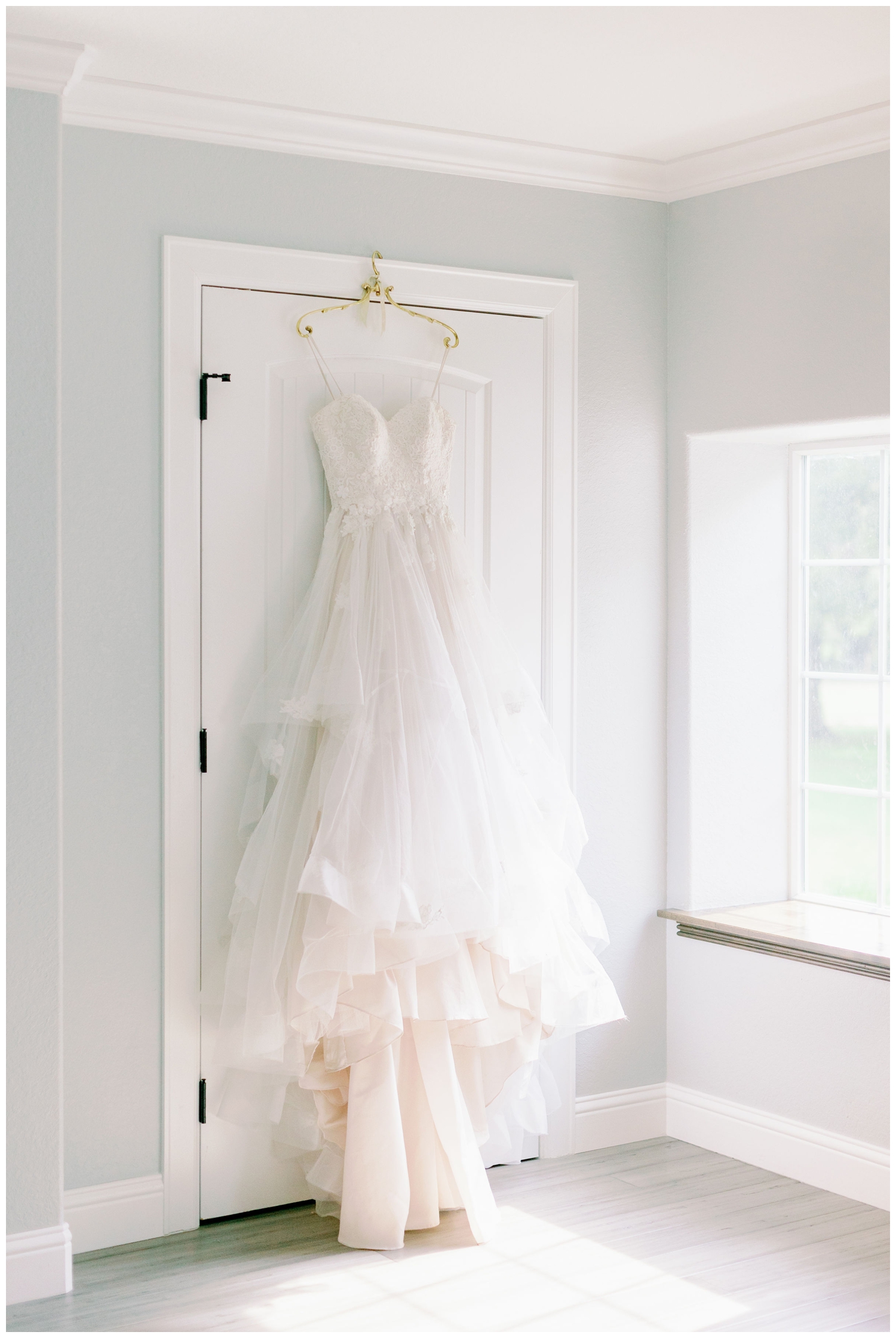 white wedding gown hangin on door
