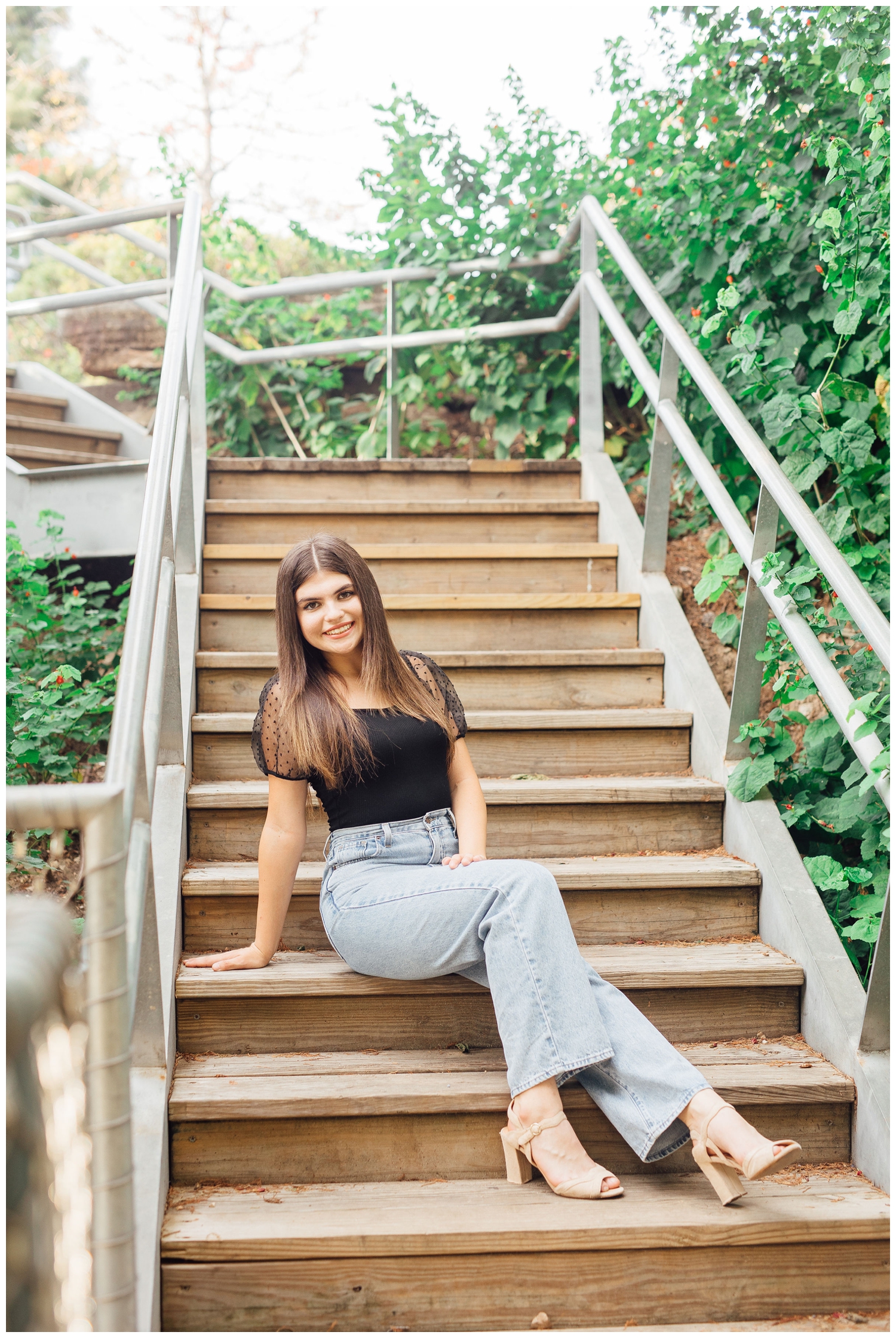 girl in jeans and black top sitting on staircase Buffalo Bayou