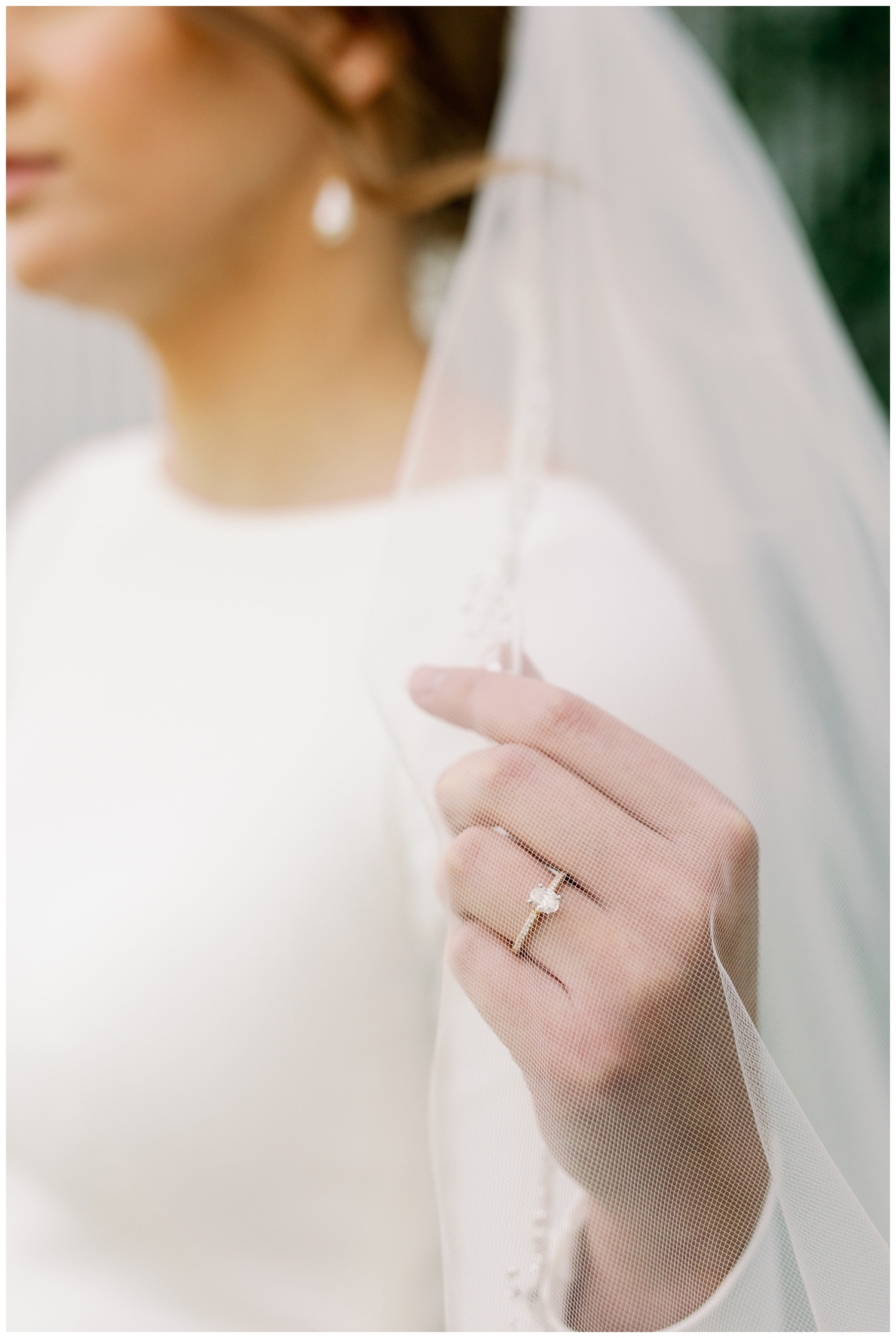 detail shot of bride's hand holding veil