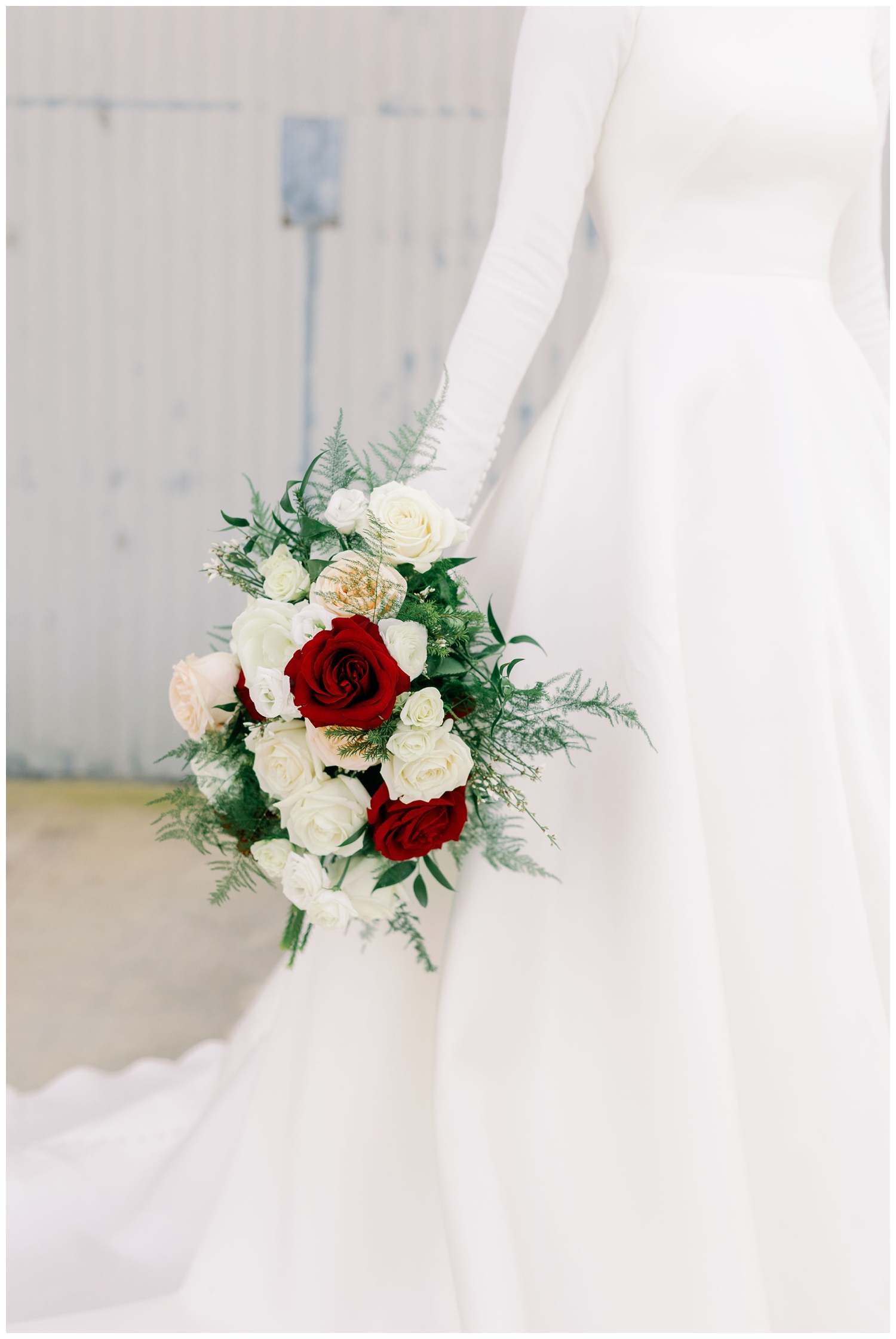 bride's arm holding white and burgundy bouquet by her side for College Station Bridal Portraits