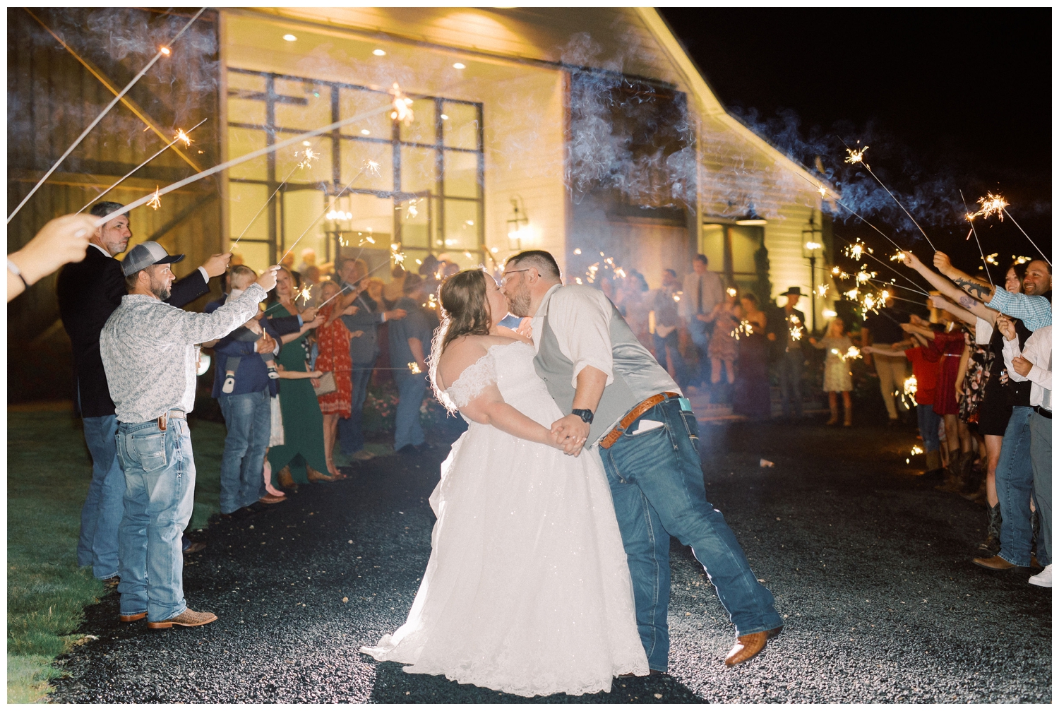 sparkler exit with bride and groom kissing College Station wedding photographer
